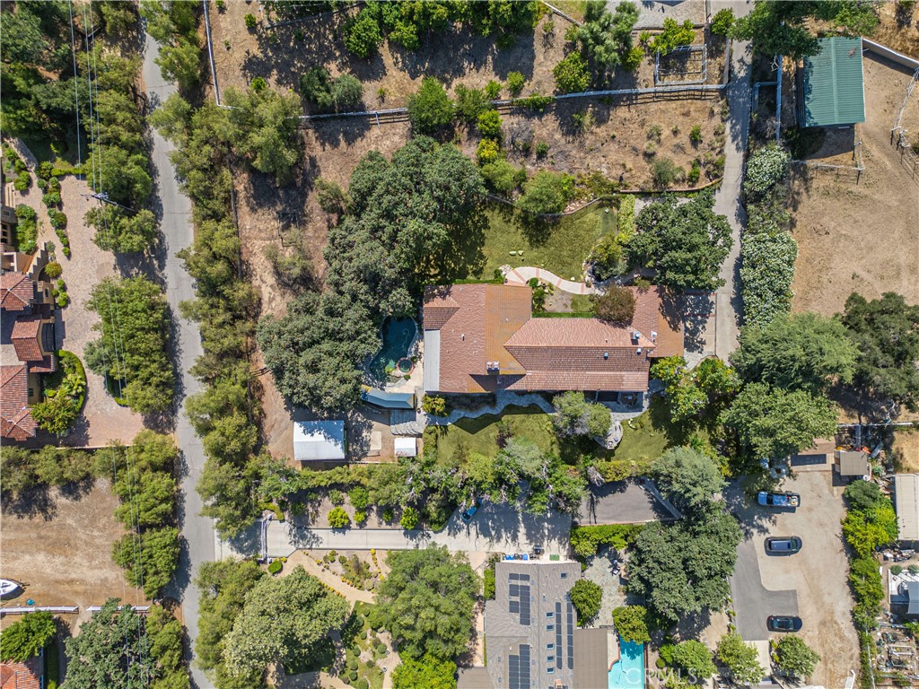 Step into a world of timeless beauty and tranquility on this exceptional equestrian estate in Old Agoura offering expansive gated frontage on Balkins Drive and main gated entrance on Colodny down a long paver drive.This 5 bed 5 bath 4244 square foot haven plus 3-car garage is masterfully curated with soul, style, and sophistication. This is more than a home; it’s a lifestyle retreat designed to inspire and restore. From the moment you enter, you’re welcomed by vaulted ceilings, rich textures, and a feeling of serene grandeur. Outside, meander thru tranquil pathways past a koi pond with cascading waterfall, or gather around the fireplace and fire pit in the dedicated outdoor crescent-s aped lounge under the stars. The secluded waterfall pool, spa and covered pergola promise peaceful relaxation or entertaining. Wraparound porches and French doors encompass all entertaining rooms abundantly embracing the home, blurring the line between indoor and outdoor living. Inside, a Parisian style “Moulin Rouge” inspired a formal living room. Grand 2-story billiard room with 1 of 3 indoor fireplaces. The family-style chef’s kitchen with 2nd fireplace and high vaulted ceilings feature a show-stopping La Cornue range and invites culinary passion. The primary suite is pure indulgence with floor-to-ceiling fireplace, retreat seating area, private covered porch, custom fitted walk-in closet and opulent European-inspired bath adorned in Venetian plaster. For those who desire a large home/work space with separate entrances, look no further. One level houses the separate 5th bed & 3/4 bath guest suite with private entrance and large covered patio; ideal as optional rental income possibility or for caretaker, groundskeeper, etc and is adjacent and attached to the multi-purpose room which currently serves as a media room, pilates and music studio-Ideal for creatives, musicians, fitness trainers, or any work/live business environment. For equestrian enthusiasts, the 2-stall barn and tack room open directly to a spacious turnout and shaded pasture offering the rare blend of luxury and country charm. This estate is a rare jewel-private, poetic, and impossible to replicate. Showings are limited and demand for a lot of this kind is high. Don’t wait-schedule your private tour now and experience the magic for yourself. Information deemed reliable, but not guaranteed.