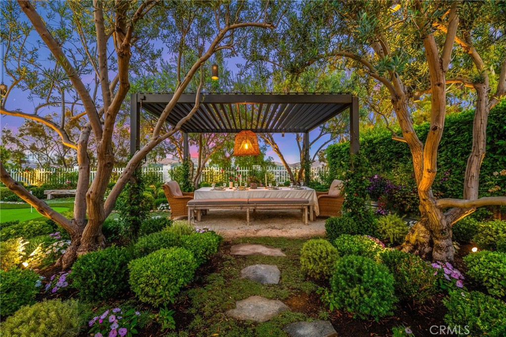Perched atop a serene hillside with sweeping views and an unforgettable garden and entertainer’s backyard, 2933 Estancia is a rare, meticulously designed single-level sanctuary that defines coastal luxury. From the moment you pass through the charming arched entry gate and Dutch door, you’re welcomed into a home that blends refined elegance with effortless indoor-outdoor living. Thoughtfully reimagined and renovated in 2022 for comfort and style, this turnkey home offers dual outdoor living areas—both front and back—perfect for year-round entertaining. The show stopping backyard is a true private retreat, featuring a covered lounge with fireplace and TV, a built-in BBQ island with refrigerated drawers, a pass-through window with buffet counter, a shaded al fresco dining area, and even a putting green—all surrounded by a lush, professionally curated garden.Recently recognized as the premier property on San Clemente’s annual garden tour, the landscape is a masterpiece in itself, offering beauty, privacy, and tranquility at every turn. Inside, the home continues to impress with Provenza hardwood flooring, high-end finishes, and magazine-worthy design throughout. The chef’s kitchen features solid maple cabinetry, Thermador appliances, a 36-inch six-burner range, and a three-unit wall system including a microwave, oven, and warming drawer. Adjacent, a walk-in pantry stuns with custom cabinetry, antique door, ample counter space, and a prep sink. The primary suite is a peaceful haven with vaulted ceilings, French doors opening to the backyard, a custom walk-in closet, and a spa-like bathroom with luxurious finishes. The property features a finished garage currently used as a playroom/laundry room/office and a spacious outdoor living room (total of 853 square feet)—perfect for year-round entertaining. While not included in the official square footage, these thoughtfully improved areas provide an abundance of flexible living and recreation options. Enjoy seamless indoor-outdoor living, with custom upgrades throughout and a backyard designed for gathering, relaxing, and making memories. Additional features include crown molding throughout, a garage with built-in workspace and smart storage, RV or boat storage, and close proximity to San Clemente’s world-renowned beaches. This is more than a home—it’s a rare opportunity to live the Southern California dream in one of the most beautifully upgraded and turnkey properties on the market.