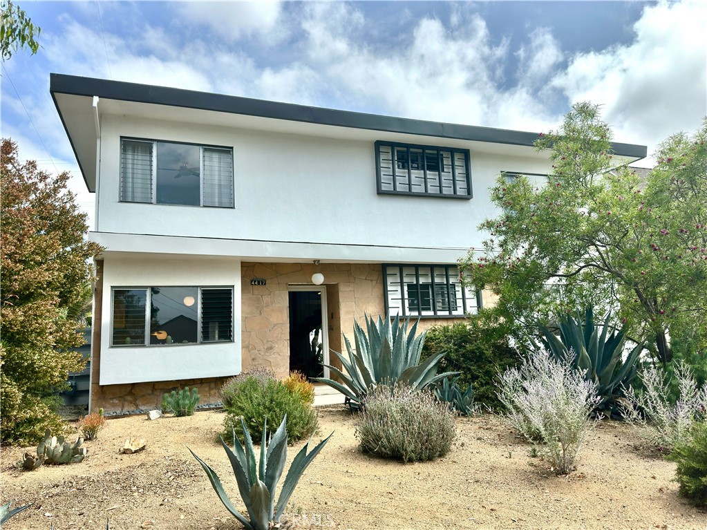 Welcome to 4417 E Harvey Way!
This award-winning built mid-century modern 1920 sf home features 4 bedrooms and 2 1/2 baths. When you enter, you will immediately see the amazing floating stairs that lead to the second story. You continue into the large bright living room with its openness and wall of glass that invites you inside. At the other end of the large space is the dining area, which is large enough for at least 8 people to sit and enjoy the open floorplan and adjacent kitchen. There are two spacious bedrooms on the first floor with 1 1/2 baths. When you ascend the stairs you find another two bedrooms with a full bath. There are lots of closet space for all your needs in each bedroom as well as common areas.
The original wood burning fireplace is perfectly situated in the living area for those chilly winter evenings.
The backyard is an ideal space to relax and enjoy a nice book under the shading tree.
There is a large 2-3 car garage in the back of the property with a storage area and workshop next to it as bonus areas which have the potential for an ADU conversion.
The front yard has climate appropriate plants, that require very little water and maintenance funded by the Long Beach ‘Lawn to Garden’ program.
The current owner is an Architect and received a preservation award from the Long Beach Heritage for its thoughtful restoration. This is an amazing opportunity to own a wonderful custom mid-century modern home in the attractive Lakewood Village.
This neighborhood offers easy access to Los Angeles, Orange County, and all the best that Southern California has to offer. It is also conveniently located near restaurants, airport, LBCC and shopping at the Lakewood Mall or LBX.