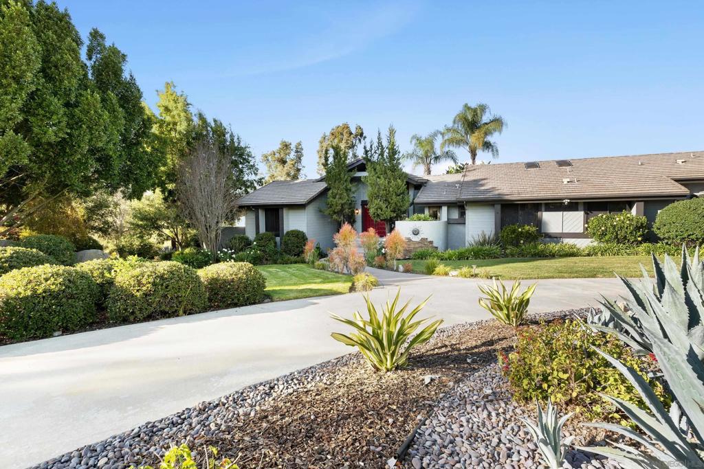 Stunning estate in Rancho Bernardo's most exclusive neighborhood. Located in "The Trails", this spectacular property offers privacy, breathtaking views & resort-style living on a 1.16 acre premier corner lot. Comprising 5,467 sq. ft. of living space, this 5 bedroom, 3.5 bath home is an entertainer's dream, providing a private retreat that seamlessly blends indoor & outdoor living. Views, views, views! Soaring wood beam ceilings. Formal dining room. Living room. Family room. Entertainers kitchen w/ walk-in pantry, center island & countertop seating. Indoor laundry. Expansive Trex-decked view balcony. Large, private primary bedroom w/ two private terraces, separate dressing area & a huge cedar-lined walk-in closet. Four fireplaces throughout. Additional downstairs living room, bedroom w/ walk-in closet & bathroom (downstairs living can be accessed from inside or outside the home!). Wet bar w/ countertop seating. Fully-fenced backyard oasis of beautifully landscaped lush grounds & majestic trees. Spectacular diving pool, luxurious spa & a large firepit create the perfect retreat for relaxation and entertainment. The property offers the possibility for one, maybe two, ADUs (in addition to the current downstairs attached living space), 3 car attached, direct access garage. Beautiful circular drive provides plenty of additional parking. For added peace of mind, the home is equipped w/ a comprehensive security system. This is a rare opportunity to own a truly remarkable estate in The Trails, where elegance meets tranquility in perfect harmony!