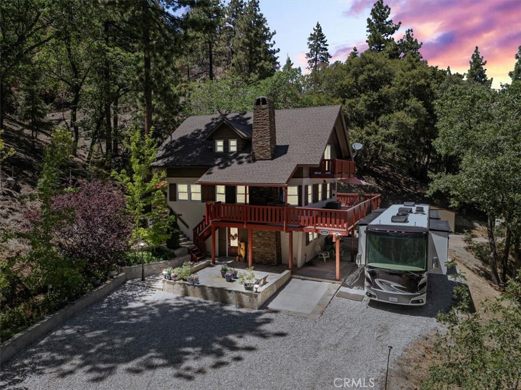 This home sets on 2.98 private acres yet is so close to the village you can walk to restaurants and shops. Featuring nearly 2200 square feet, 4 bedrooms and 3 baths, this home has been upgraded with high end finishes including Thermador appliances and Pottery Barn vanities in 2 of the baths. The home has been beautifully maintained inside and out. Stone and concrete patios and a wrap around deck are found here. The 1 year new 6 seat hot tub remains with the property. All trees and plantings are on an automatic drip system. Newly installed gutters and a 2 years new 40 year roof are a major plus! Knotty alder cabinetry, travertine flooring and granite counters are found in the kitchen, bath and laundry area. The fireside pool table room is finished with a bar, bar stools and chairs, the table and the furnishings may remain with the home. Some of the furnishings inside and outside are negotiable or can be purchased separately. There is 50 amp service for an RV too!