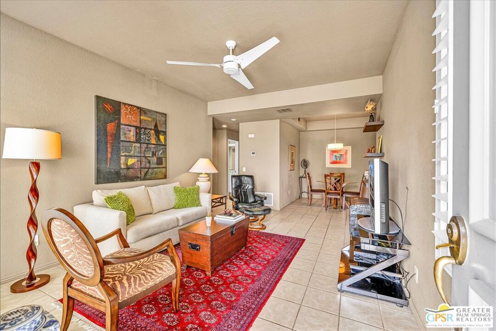 Rare opportunity! This beautifully maintained 1-bedroom, 1-bath ground-floor condo offers 768 sq. ft. of comfortable living space and one of the largest patios in La Palme.Step inside to an open, flowing floor plan with high ceilings, plantation shutters, ceiling fans, and sleek tile flooring throughout. The spacious kitchen provides ample cabinet storage, while the updated bathroom features a modern vanity and a tiled walk-in shower. The very large enclosed patio accessible from both the living room and the bedroom, is the true highlight. Perfect for entertaining, enjoying meals outdoors, or simply relaxing with your morning coffee or evening cocktail, this private space extends your living area beautifully.Additional conveniences include indoor laundry and an assigned covered parking space. La Palme is a highly desirable gated community featuring 6 sparkling pools and spas, 3 tennis courts, and two EV charging stations. HOA dues cover roof maintenance, Wi-Fi, water, trash service, and even basic cable with HBO. As a non-smoking community, La Palme offers a serene environment in the heart of Palm Springs.Don't miss your chance to own this dream desert retreat with one of the largest patios in the community!