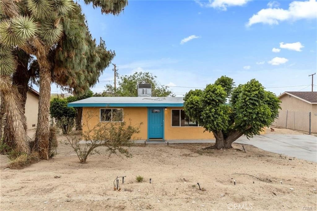 Motivated Sellers – Ready to Review Your Offer!
Welcome to your desert oasis in the heart of the desirable Joshua Tree Village! This beautifully upgraded 1960s classic has been transformed into a stylish modern boho retreat—and it comes fully furnished for a truly turnkey experience.
Step into a spacious open-concept layout featuring a large living room with tile flooring. The updated kitchen shines with newer cabinets, quartz countertops, stainless steel appliances, recessed lighting, modern fixtures, and a breakfast bar that opens to the dining area. A sliding glass door leads you to a huge backyard—fully fenced with wood fencing for added privacy—complete with a covered aluminum patio and fire pit, perfect for stargazing or entertaining under the desert sky.
The single bathroom has been updated with a modern vanity and tile flooring. Throughout the home, you’ll find newer windows, fresh interior and exterior paint, upgraded flooring, and new fixtures.
This 3-bedroom home is truly move-in ready and ideal as a primary residence, vacation getaway, or income-producing short-term rental—with a STR permit already previously approved and issued!
While tax records show 2 bedrooms, the garage has been converted into a third bedroom, offering extra space and flexibility. Bonus: Transferable solar panels help reduce energy costs year-round.
Located just minutes from the Joshua Tree National Park entrance and close to local dining, entertainment, and shopping, this is desert living at its best.
Don’t miss your chance to own this Joshua Tree gem—schedule your showing today!