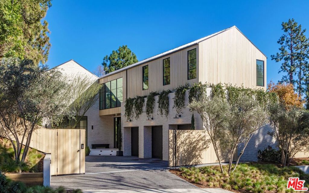 Just completed contemporary farmhouse invites nature & incredible sunlight into every room with the most gorgeous organic materials & a serene, open interiors on an 18,300 flat lot. Everything you need is in this dream home; chefs kitchen, office, pajama lounge, gym/spa, entertainment rooms & garage w/ car lift that are perfect for the modern family that wants all the greatest amenities w/ the warmth of the Beverly Hills lifestyle. Interiors radiate tranquility w/ 25-ft exposed brick wall entry, bleached wood siding, white oak & vaulted beam/wine barrel ceilings. Perfect indoor-outdoor living w/ guestroom zen garden, 2nd-floor terraces, firepits & resort-like backyard w/ saltwater pool/spa through 11ft oak-interior steelcase glass windows. Uninterrupted entertaining flow continues to a daylit recreation basement w/ state-of-the-art theater by light well, glass wine display & bar. 6 bedrooms w/ ensuite baths & walk-in closets. A lavish primary suite w/a large bath including a soaking tub. Ultimate private sanctuary among the most prestigious estates in Beverly Hills.