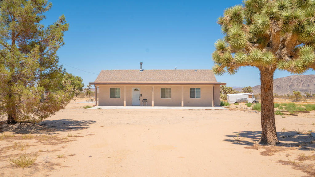 Welcome to this beautifully maintained home, built in 2010, offering 3 spacious bedrooms and 2 full bathrooms -- including a master suite with its own private bath. Nestled on a generous 4.8-acre lot, this property combines comfort, space, and stunning desert views. (Corner Lot)Enjoy cozy evenings by the fireplace in the living room, or take in the breathtaking surroundings from your own backyard. The open layout and natural light create a warm, inviting atmosphere throughout the home.This property features central AC and heating, an attached 2-car garage, and RV hookups with 220V power. Utilities are extended throughout the property, and there's a separate fenced area that's perfect for pets or any furry family members. The home is move-in ready and offers the perfect blend of rural charm and modern convenience.Located in the heart of Landers, you're just minutes from the Landers Post Office, the world-famous Integratron, Giant Rock, and more. Whether you're looking for a full-time residence, vacation getaway, or investment opportunity -- this is a must-see! We have all the blueprints.