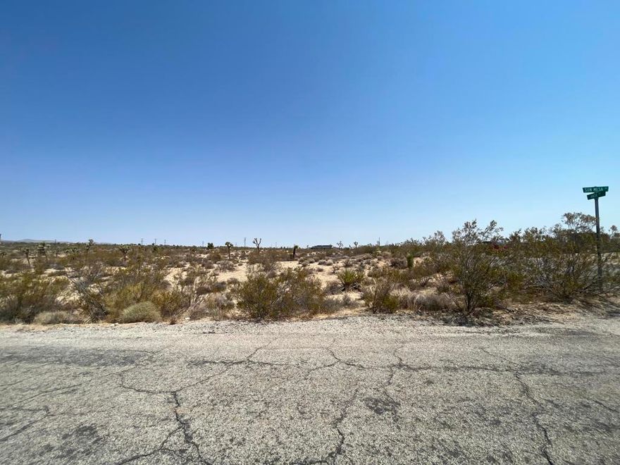 Prime 4.35-Acre Corner Lot in Booming Yucca Valley!Don't miss this rare opportunity to own a 4.35-acre corner lot on a paved road with water and power at the street. Located in a fast-growing neighborhood surrounded by new construction homes--many operating as high-performing short-term rentals--this property features multiple mature Joshua Trees and stunning mountain views. Just minutes from the Joshua Tree National Park entrance, it's the perfect spot to build your desert getaway or next investment property.