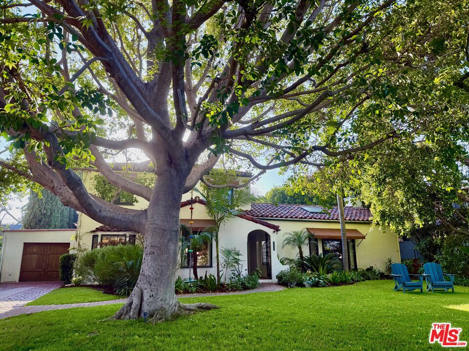 Tucked away in one of LA's most sought-after neighborhoods, Colfax Meadows, is a place where time slows down. People stroll leisurely along tree-lined streets, kids ride their bikes and there's a 4th of July parade with the local firefighters. It's a community with heart and soul. 4277 Beck is that rare SPANISH architecture rich with character and stately charm. As you approach the oversized lot, the first thing you notice is a 1937 home set back far from the street, with a generous front lawn. A mighty tree greets you, its branches casting dappled shadows across the yard where you can sit on the grass, relax and watch the world go by. In this magical setting, you can't help but feel you've travelled back in time. Pass through the arched entry to find a beautifully remodeled interior blending modern updates with authentic Spanish style. A curved staircase leads your eye to a stained-glass window and original 1930s light fixtures, creating a timeless atmosphere that highlights enduring craftsmanship. The high-beamed living room is dramatic and captivating, complete with a crackling wood-burning fireplace (also plumbed for gas). The ceiling, meticulously restored to its original grandeur, adds an undeniable sense of history. Step into the formal dining room, where a large picture window offers sweeping views of the expansive, lush yard. The renovated kitchen features a large center island, built-in corner seating, and gourmet features like a Viking range, warming drawer, two dishwashers, and a walk-in pantry perfect for modern living and entertaining. Enter the main level primary suite and find yourself immersed in luxury. In the stunning sunlit bathroom, no expense has been spared, including Heath Ceramic tiles, top-of-the line fixtures, powered window blinds and a powered skylight above the oversized shower. Completing the primary suite is a generous walk-in closet with accent lighting. Curiously, in the bedroom you might notice there's no television. That's because you'll be watching your favorite shows on a 10-foot screen which automatically lowers from the ceiling at the press of a button. And thanks to commercial-grade sound-proofing in the walls, no one else in the house will be bothered by your powerful in-wall 5.1 sound system. Also on the main level, you'll find a second bedroom suite with full bath and walk-in closet, ideal for younger children, teens or guests. Upstairs, three additional bedrooms and two baths accommodate families of all sizes. In the courtyard, the firepit seating and al fresco dining areas enhance the coveted outdoor So Cal lifestyle. The backyard romantic sparkling pool and spa are shaded by towering privacy trees. Adjacent to the pool, your final discovery is perhaps the most special; a detached ADU/Guest House containing a state-of-the-art movie theater, so extraordinary that celebrities have requested it to screen movies for friends. The structure, which also contains a separate office and bathroom, has its own address, making it a unique value-add for anyone who works from home. Timeless appeal, timely finishes and design. Your forever home.