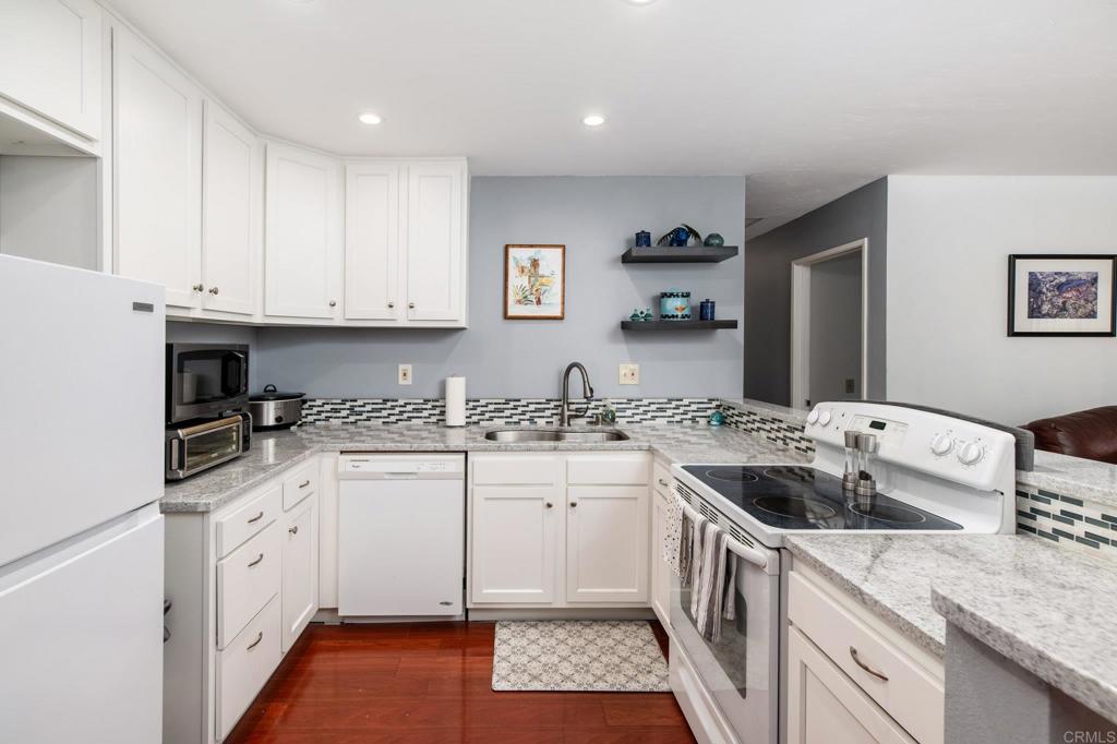 Upper Corner Unit in Mission Park with Updated Kitchen and Baths Welcome to this bright and airy 2-bedroom, 2-bath upper-level corner unit in the desirable Mission Park community. This 940 SF condo features a freshly renovated kitchen that’s been opened up for seamless flow into the living room, complete with hardwood flooring in the kitchen, dining, and living areas. A cozy fireplace (unknown condition) and private balcony add charm and comfort. The remodeled kitchen features newer cabinetry, raised ceiling, granite countertops, tile backsplash, updated sink and faucet. Both spacious bedrooms are filled with natural light and feature plush carpet, which continues into the hallway for added comfort. The primary bathroom includes a newer toilet, tile flooring, and updated plumbing connections. Both bathrooms feature reglazed tubs, and the secondary bath will have brand-new tile installed prior to close of escrow. Additional highlights include ceiling fans in the dining area and both bedrooms, full-size in-unit laundry, and a generously sized balcony with a storage closet. Enjoy resort-style living with community amenities including a swimming pool, gym, BBQ area, electric vehicle charging stations, and well-maintained grounds. HOA dues also cover exterior maintenance, insurance, pest control and water, sewer and trash Conveniently located near shopping, dining, and freeway access—this move-in ready home offers comfort, style, and value.