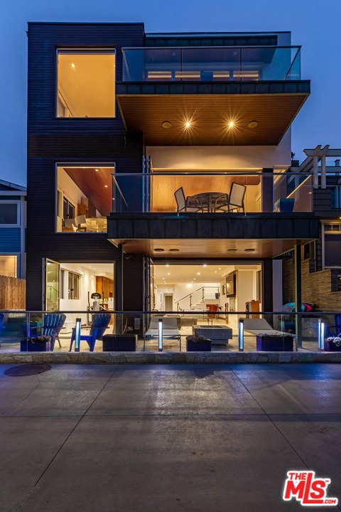 A rare and unique opportunity to purchase a private custom built home by one of the most successful developers in the South Bay. The homes features almost 5,000 sf of luxury quality & high end finishes - no expense was spared. This magnificent Modern has 180 degree views from Malibu to Manhattan Beach Pier, just 4 blocks away.The master suite encompasses the entire front portion of the top floor w/ a spacious balcony, his/hers separate cabinets, huge master closet. 2 addtl spacious bedrooms share a large bath. The middle floor features entry way, powder room & great room w/ kitchen & family room & a beautiful glass fireplace. Custom made Koa furniture throughout. Bottom floor features a full bar made of exotic leopard wood w/ white marble counters. Large family & play room w/ fireplace & surround sound. Large bedroom w/ sitting area. Full laundry room & spacious bath to service bedroom. Huge all mahogany wine cellar. Private massage room. 3 stop elevator.