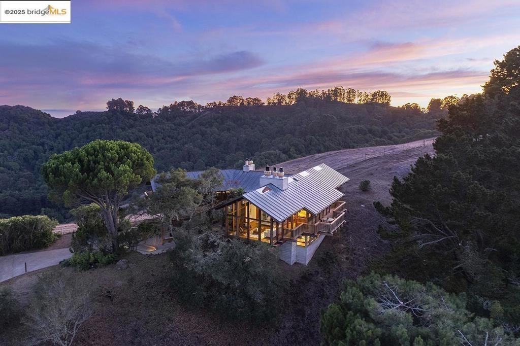 Inspired by the VanDamm house in Alfred Hitchcock’s North by Northwest, this architectural masterpiece offers jaw-dropping views and unparalleled seclusion and privacy within minutes of downtown Orinda and Berkeley and just steps to hiking trails. Designed and built by the owner for the owner this unique structure offers powerful angles, rugged materials, and a back to the earth vibe amidst a backdrop of nature in the masterful style of Frank Lloyd Wright. Massive beams meet at improbable angles, the living room and primary bedroom fully cantilever as if floating in space with floor to ceiling glass and views of Briones Reservoir, Mt Diablo, and EBMUD watershed. Hawks circle, turkeys gobble, and quail squabble in this magical retreat perched on its aerie at the top of the world. Featuring balconies off almost every room, 4 full bathrooms, large family room, quiet and gentle hydronic heating, separate built-in Subzero freezer and refrigerator, 60” gas range with 6 burners and 24” griddle, large garage and workshop space, almost all new lighting, new outlets/switches, gleaming oak floors, 22 new windows, 80 gallon Bradford White Heatpump water heater, and a new boiler.