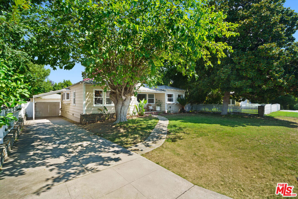 Tucked away on a peaceful cul-de-sac in West Toluca Lake and just moments from Toluca Lake Elementary and major studios, this charming 2-bedroom, 2-bathroom vintage gem blends timeless character with thoughtful updates. The cozy living room features vaulted ceilings, hardwood floors, and French doors that open to a tranquil outdoor retreat. Original architectural details arched shower and tub, classic sconces, and fireplace enhance the home's enduring appeal. The formal dining room sits just off the kitchen and offers an elegant space for entertaining. A dedicated laundry room is conveniently located near the guest bath. Outside, an entertainer's patio wraps around the home and opens to a spacious, fenced backyard perfect for pets, playtime, or relaxing under the trees. The large lot offers potential for expansion. A detached shed currently serves as a quiet office, and the two-car garage provides generous storage and potential for future ADU conversion (buyer to verify). A porte-cochre and long driveway offer stylish, covered parking with additional space. Close to Riverside Drive, the NoHo Arts District, Tujunga Village, Universal Studios, cozy coffee shops, and beloved local restaurants this is the one you've been waiting for!