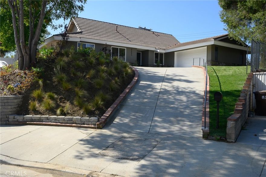 Beautifully UPDATED 5 bedroom, 3 bathroom home with stunning mountain and hill views in a desirable Hacienda Heights neighborhood.  This home sits at the end of a cul-de-sac street with approximately 2441 sf of living space with an open concept living space.  The kitchen has new custom two-tone cabinets, full tile backsplash, sleek new counter tops, new fixtures, stainless steel appliances, a large center island offering additional counter space and seating and a large walk-in pantry with an abundance of storage space.   The bar space is great for hosting with a built-in wine fridge, wet bar area and built-in display cabinet.   Downstairs you will find a living room with a decorative fireplace, dining room, kitchen, a den area that leads to one of the backyard patios, 3 bedrooms and 2 bathrooms.  The primary bedroom is spacious with an ensuite bathroom, walk-in closet with custom built-ins, mountain views and sliding door that leads to another outdoor patio.  Upstairs there are two additional bedrooms, both with mountain views and an additional bathroom.  All the bathrooms have been upgraded with custom tile work, new fixtures and vanities.   Other features include freshly painted interior and exterior, energy efficient windows and sliding doors, new interior doors, luxury flooring throughout the living areas and bedrooms, stylish plumbing and lighting fixtures, HVAC, and direct access to the two-car garage.   The enclosed backyard is perfect for entertainment with stunning views, two patio areas and landscaped with new sod.  This home is conveniently located and just a short distance to award winning schools, the world-renowned Hsi Lai Temple, shopping and restaurants, and local freeways.