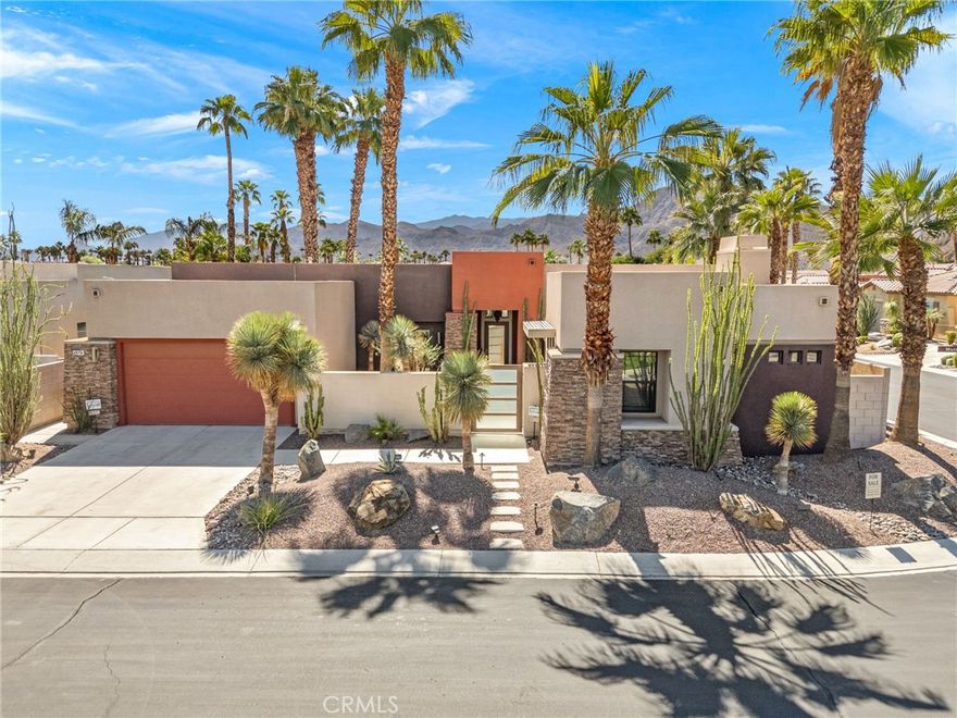 This highly upgraded contemporary home in the desirable Montage community offers resort-style living on an oversized interior corner lot providing a greater sense of openness. Well maintained and move-in ready, it features 3 bedrooms, 3.5 bathrooms, a flexible living room or office, and a separate detached guest casita. The open-concept layout flows effortlessly from the chef’s kitchen—with slab granite countertops, dual ovens, and a large breakfast-bar into the spacious great room and out to a covered patio overlooking the saltwater pool, spa, fire pit, and an outdoor fireplace. The property showcases a beautifully designed and professionally landscaped desert oasis, with mature fig and lemon trees, and a variety of stunning palms and cacti gracing both the front and rear yards, creating a lush, private retreat. Additional highlights include a total of three fireplaces, speaker system throughout interior, and low-maintenance desert landscaping. Energy efficiency abounds with a Lennix top-of-the-line duel HVAC systems and a Vivint Solar lease for low monthly utility costs. Montage residents enjoy a complimentary Social and Fitness Membership to Mission Hills Country Club included in the low $400 monthly HOA fee. Ideally located just minutes from golf, dining, and Palm Springs nightlife, this home blends luxury, comfort, and efficiency in one perfect desert escape.