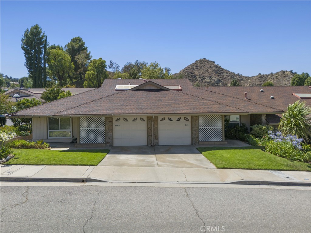Welcome to 26817 Oak Branch Circle, a well-maintained 2-bedroom, 2-bath home located in the highly sought-after 55+ community of Friendly Valley. This desirable floor plan features an abundance of natural light, laminate plank flooring, recessed lighting, and a rock-accented corner fireplace in the living room. The kitchen includes ample cabinetry, updated countertops, a double sink, built-in appliances, and a window overlooking the private enclosed patio with a mountain view ideal for entertaining or enjoying quiet outdoor time. A separate dining area includes a butlers pantry, ceiling fan, and mirrored accent wall. The primary suite offers double-door entry, two wall-to-wall closets, recessed lighting, and an updated en-suite with walk-in shower. The secondary bedroom provides direct access to the enclosed atrium perfect for an office, guest room, or flex space. The full bathroom has been fully remodeled with modern finishes. Additional features include washer/dryer hookups, a one-car garage with attic access for extra storage, and central HVAC. Residents of Friendly Valley enjoy access to 9-hole and 18-hole golf courses, a renovated pool and spa, 24-hour security, sport courts, clubhouse facilities, fitness center, hobby rooms, and more. Conveniently located near shopping, dining, Costco, and freeway access. This move-in ready home offers comfort, convenience, and the lifestyle youve been looking for.