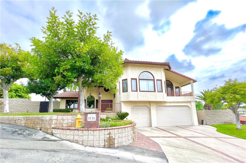 Welcome to this custom-built residence perched high above the neighborhood, offering exceptional privacy and stunning hill views from every angle! This beautifully maintained home features include a finished 3-car garage and a very private location on a 0.40-acre lot. Outdoor living is ideal here with a sparkling pool and spa, sunny patio areas, covered patio for shaded relaxation, and multiple levels of entertaining space surrounded by lush, sprawling lawns. Step inside to a warm and inviting formal entry, highlighted by custom Italian light fixtures in the formal living, dining, and casual dining areas. The living room boasts a custom brick-accented fireplace with charming raised brick window seats, perfect for cozy evenings. The light-filled kitchen includes a bay window breakfast nook, smooth neutral countertops, 5-burner cooktop, new oven, pass-through window for easy entertaining, and abundant cabinetry for storage. Enjoy endless space in the expansive family room, complete with custom built-ins, a wet bar, a unique "bee hive" fireplace, and sliding glass doors that open to the outdoor entertainment areas. A large laundry room and convenient ¾ bath are also located on the main level. Upstairs, the spacious primary suite offers a private view balcony, mirrored wardrobe closets, and an en suite bath with spa tub and separate shower. Additional upstairs highlights include a secondary bedroom with balcony access, a third bedroom with access to "Grandma's Attic" storage, and a sun-filled bonus room with wraparound windows, wood-beamed ceilings, and another private balcony.