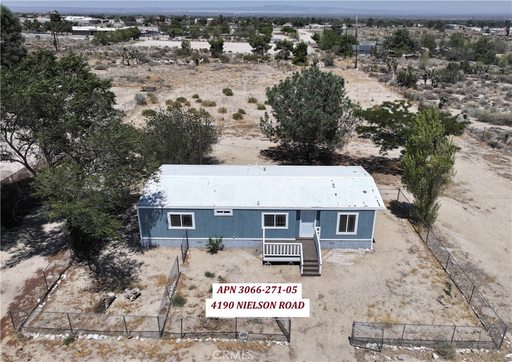 Zoned Commerical General located right off paved Nielson Road. Great location and Visibility. plenty of parking for customers, Mobile home has been remolded, split unit ac/heat will be installed prior to COE. Buyer to verify what type of business is allowed per county. Not many commerical properties available in the area. Come take a look.