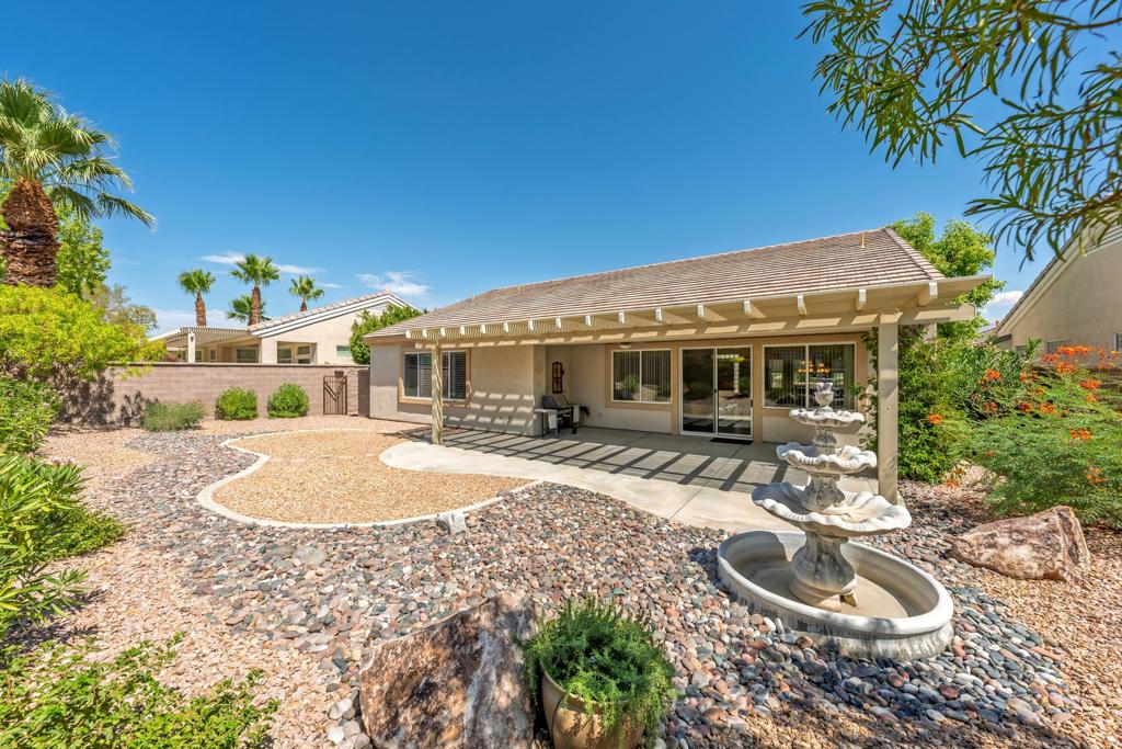 Sun City Palm Desert - St. Croix. Sitting in a premier location, just around the corner from the Lakeview Clubhouse, fitness center and pool. This version of Sun City's most popular floorplan has a 3 car garage. It has a spacious, private, south facing your yard with an extended patio, alumawood patio cover, cured planters and with no homes flush behind it, a bright and open field. A gated front courtyard provides curb appeal and function. Inside, there are 2 bedrooms, 2 bathrooms and a den. Tile flooring is in all but the bedrooms. The spacious greatroom has a slider to the rear patio. The kitchen features speckled corian counters with rounded edges, a breakfast bar, double wall ovens and a chef's island. Raised panel maple cabinetry is in the kitchen and bathrooms. The spacious primary suite has shutters and a large walk-in closet. A pocket door opens to its bathroom that has dual sinks, a stall shower with glass doors. Surfaces are cultured marble. A tub/shower is in the guest bathroom. Laundry is located inside the home. The 3 car garage has a work bench and room for ample storage. The home is equipped with a central vacuum.