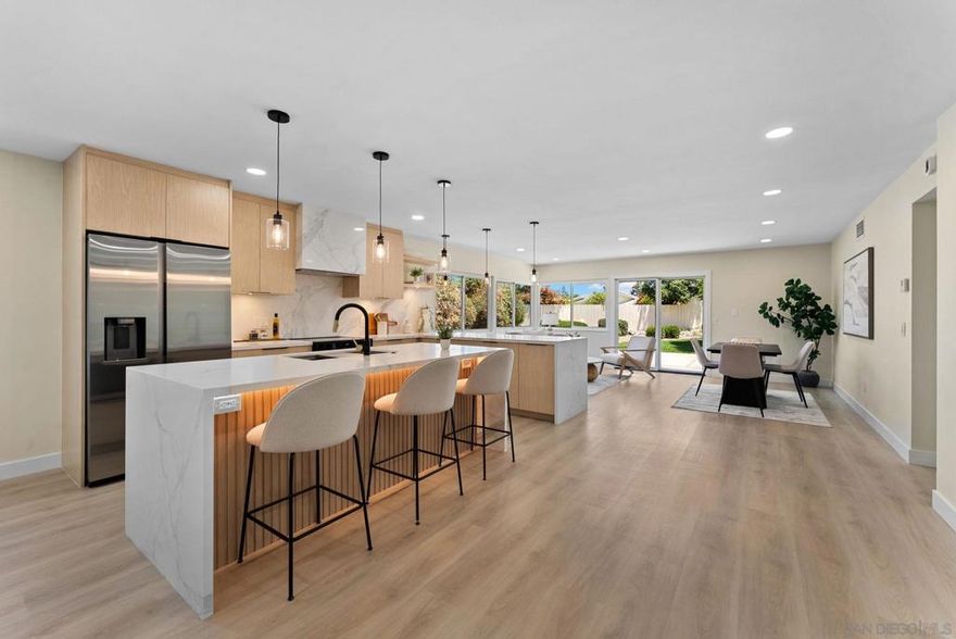 Welcome to this beautifully reimagined 5-bedroom, 3-bath residence—where designer detail and California comfort come together in perfect harmony.  Step inside to a bright, open-concept living space that immediately impresses. At the heart of the home is a showstopping chef’s kitchen, complete with white oak cabinetry, waterfall-edge quartz countertops, and a stunning statement backsplash. A full suite of premium stainless-steel appliances and an oversized island with pendant lighting make it the ideal space for cooking, gathering, and entertaining.  The kitchen flows seamlessly into the dining and living areas, framed by expansive glass sliders that open to a lushly landscaped backyard—creating the ultimate indoor-outdoor connection. Wide-plank luxury vinyl flooring runs throughout, adding warmth and sophistication to the modern design palette.  Every bathroom in the home has been fully transformed with designer tilework, floating vanities, and contemporary fixtures that elevate everyday living. With five bedrooms, there’s space for family, guests, or a dedicated home office.  Set on a peaceful street in one of Rancho Bernardo’s most desirable neighborhoods, this turnkey home offers convenience to award-winning schools, shopping, dining, golf courses, and parks.  Stylish. Spacious. Move-in ready. This is the modern Rancho Bernardo lifestyle at its best.