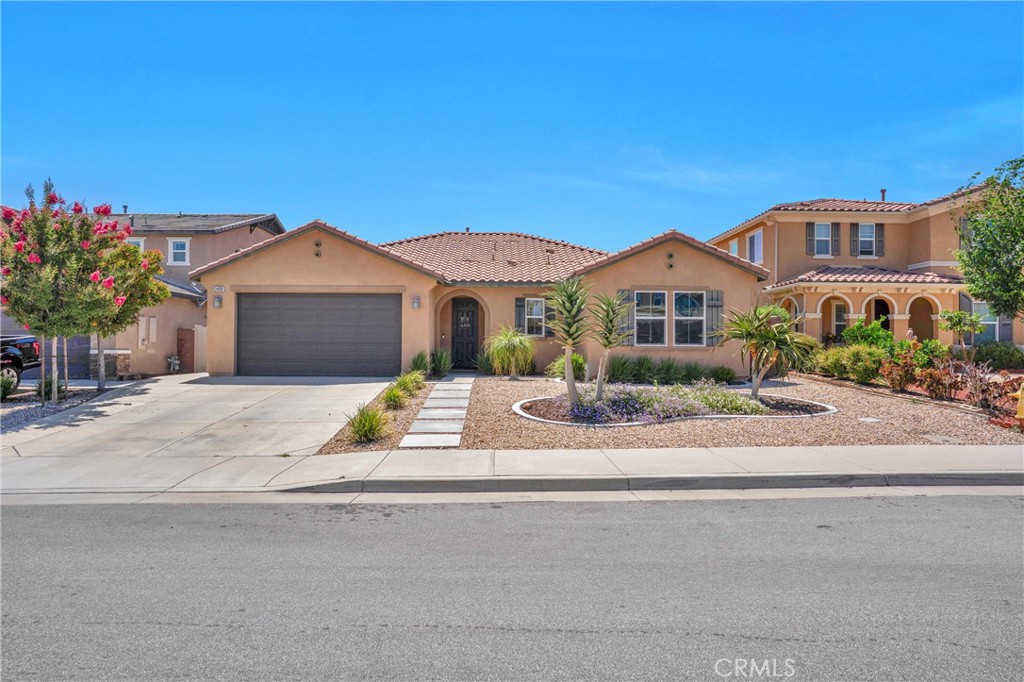 Welcome to this stunning 3 bedroom, with possible 4th bedroom and 2 bath, turnkey single-story home in Mahogany Hills, nestled on a quiet cul-de-sac within the desirable Spencer's Crossing community. This beautiful residence features an open floor plan with an array of fabulous upgrades.
As you step inside, you're greeted by a spacious entryway that seamlessly flows into the open concept kitchen, living room, and dining area. Elegant luxury vinyl plank flooring extends throughout the home, adding a touch of sophistication. The expansive kitchen boasts a large concrete island that comfortably seats at least four, complemented by an upgraded built-in stove top and oven. You'll find ample storage with a generously sized pantry and plenty of cabinets (self closing) finished with stylish basket-weave tile backsplashes, quartz counters and decorative cabinet lighting. The dining and living areas are perfectly designed for entertaining, with abundant natural light pouring in through large windows and sliding doors that lead to the backyard—ideal for indoor-outdoor living. This home includes two additional bedrooms and a guest bathroom, providing plenty of space for family or guests. The laundry room is equipped with a sink and upgraded cabinets for added convenience. As you make your way down the hallway from the great room, you'll discover charming barn doors that open to a versatile den, office, or bonus room. This space can easily be transformed into a fourth bedroom to suit your needs. The primary bedroom is a true retreat, featuring a spacious walk-in closet and large windows that fill the room with natural light. The primary bath offers a separate shower and tub. Outside, the front and backyard are designed for low maintenance and drought resistant, featuring hardscaping with large stepping stones, rock plants, and concrete curbing in the front. The backyard is perfect for entertaining, boasting a covered concrete patio with a ceiling fan, artificial turf, a fire pit, and a full retaining wall with a few fruit trees. The garage features epoxy flooring and attached overhead storage, adding to the home's functionality. Additional highlights include a water filtration system for clean and refreshing water. The Spencer's Crossing community is rich in amenities, with numerous parks and walking trails, making this home the perfect blend of luxury, convenience, and an active lifestyle.