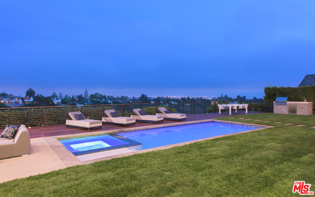 It is a rare offering in Brentwood. Located on lower Westridge Road, this just completed modern-traditional home invites the perfect buyer who wants volume, open spaces, tons of light and gorgeous views. Private and gated, you enter a secluded world to entertain or simply enjoy the rich finishes and outdoor lifestyle. This home offers five bedrooms plus an office and ceilings that are twelve feet high in every room. Stunning state of the art kitchen and fireplace, huge formal dining room (or family room), large living room and entertainment bar. Every room opens to the views. There is a spacious backyard, huge deck, lovely pool, and barbecue area -- all to enjoy the beautiful sunsets.