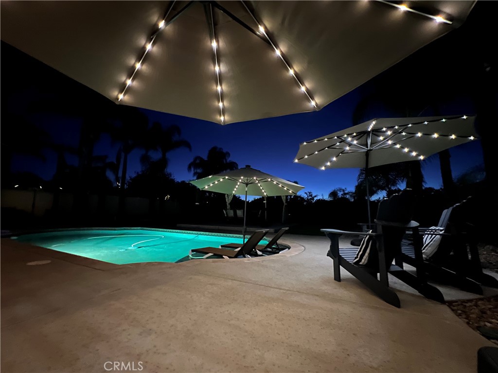 Welcome to your ONE-OF-A-KIND Temecula Dream Home in the prestigious Vintage Hills, on a massive 13,000+ sqf lot, within walking distance of Temecula's Wine Country! Enjoy the SINGLE STORY PERK with a large Downstairs Main Bedroom Suite - a rarity in this Town. This remodeled 2,325 sq ft, 4-bed, 2.5-bath gem boasts an open-concept design with soaring vaulted ceilings and picture windows flooding the living, dining and kitchen areas with natural light and greeting you with lovely views every which way you turn. The updated white Gourmet kitchen shines with quartz countertops, subway tile, custom cabinets, an Island with bar seating, and modern stainless steel appliances. Unwind in the spacious family room with 5.1 surround sound or entertain in the HUGE backyard featuring a Mini Pebble refinished pool with Baja shelf, patio, gazebo, and lush lawn—perfect for gatherings and with room for a Guest House/ADU. Smart features include Blink security, Kwikset fingerprint lock, MyQ garage opener, and iAquaLink pool controls. Enjoy ceiling fans in all bedrooms, commercial grade luxury vinyl plank flooring, new carpet, remodeled bathrooms with stylish vessel sinks, and a 3-car garage with lots of storage shelving. The private, sunset-facing Backyard rivals Resort Hotels - large and grassy, with a connected indoor/outdoor speaker system, charming market lights, an oversized gazebo, a wide patio cover, generous side space for storage and dog run, and western views on an elevated lot - a perfect setting for your BBQs, large parties, and even small weddings. With top-rated Temecula schools, no Mello-Roos, and an approx. 1.10% tax rate, this home blends style, tech, fun, and comfort in an ideal location!