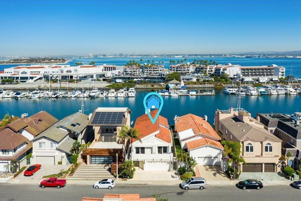 This beautiful home features 3 bedrooms/4 bathrooms, boasting a vaulted entry & an open floor plan perfect for indoor/outdoor entertaining. Spacious Loft is great for an office. The property includes a large patio right on the water, offering direct access & a private boat dock. Wharfage is capable of accommodating a 75' yacht. Situated on a spacious channel, it provides breathtaking sunset & panoramic views. The home also includes a luxurious primary bedroom suite with views from the balcony. Must see to appreciate.