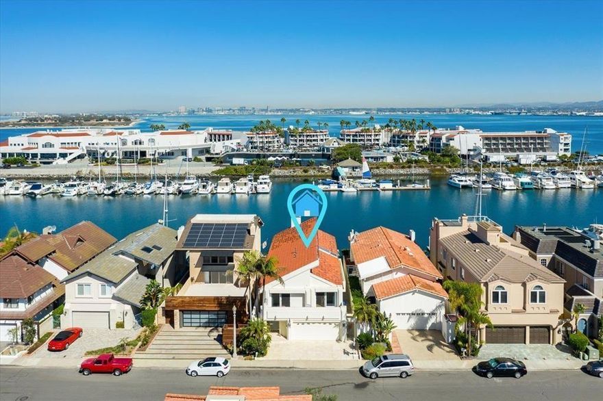 This beautiful home features 3 bedrooms/4 bathrooms, boasting a vaulted entry & an open floor plan perfect for indoor/outdoor entertaining. Spacious Loft is great for an office. The property includes a large patio right on the water, offering direct access & a private boat dock. Wharfage is capable of accommodating a 75' yacht. Situated on a spacious channel, it provides breathtaking sunset & panoramic views. The home also includes a luxurious primary bedroom suite with views from the balcony. Must see to appreciate.