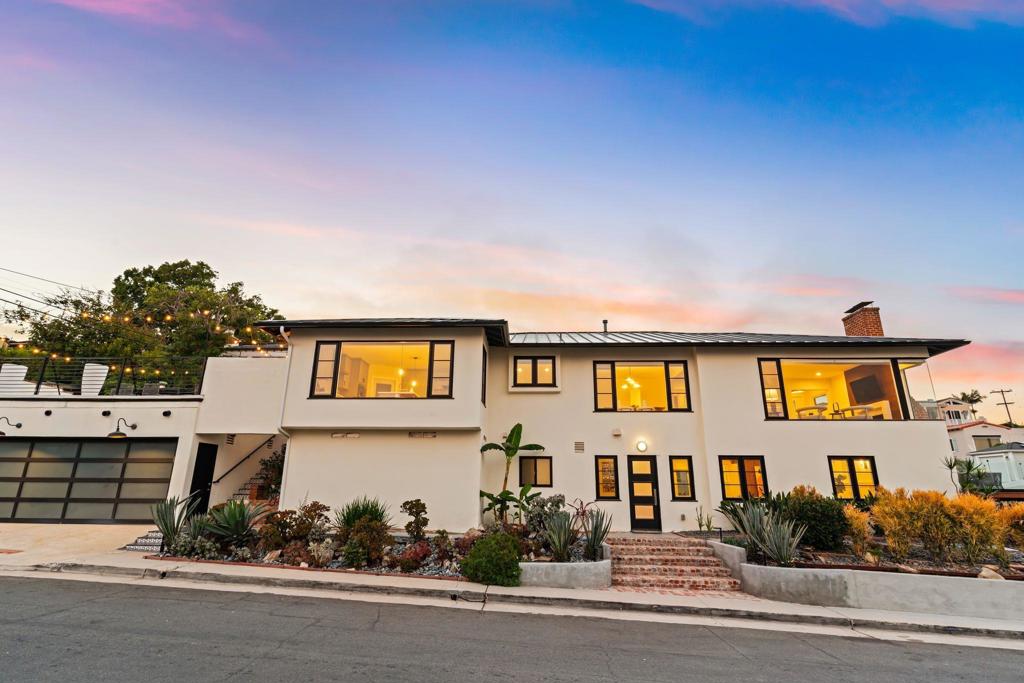 WELCOME HOME! Elegantly situated on the scenic hills of Point Loma, this radiant mid-century corner lot home captures the essence of sophisticated living with A new wood deck that captures San Diego’s finest bay views then step inside to find large windows that artfully frame sweeping cityscapes, shimmering water views and distant mountain vistas. The interiors are adorned with luxurious modern finishes, featuring a chef’s kitchen equipped with professional-grade appliances, a chef’s range, a wall-mounted pot filler, double oven and an expansive island—perfectly designed for entertaining. Thoughtfully appointed with central air and heating, an impressive wine cellar, a NEW principal Bedroom designed with a double sink & marble tile. Followed by a NEW powder room addition designed with Mable floors & wainscoted walls. The laundry room is conveniently located and there is a Tesla charging station within the impeccably finished epoxy-coated 3-car garage, every detail has been meticulously crafted for elevated living. Seamlessly blending indoor and outdoor living, this home offers a drought-tolerant yard, beautifully complemented by a rooftop deck that invites relaxation and endless enjoyment of the breathtaking views. The elegantly remodeled bathrooms showcase designer finishes and timeless tilework, exuding a sense of luxury. The lower level of this BEAUTIFUL home presents a cozy family room, bedroom/office, complete with its own entrance, with the potential for an ADU over the garage and a yard large enough for a pool!