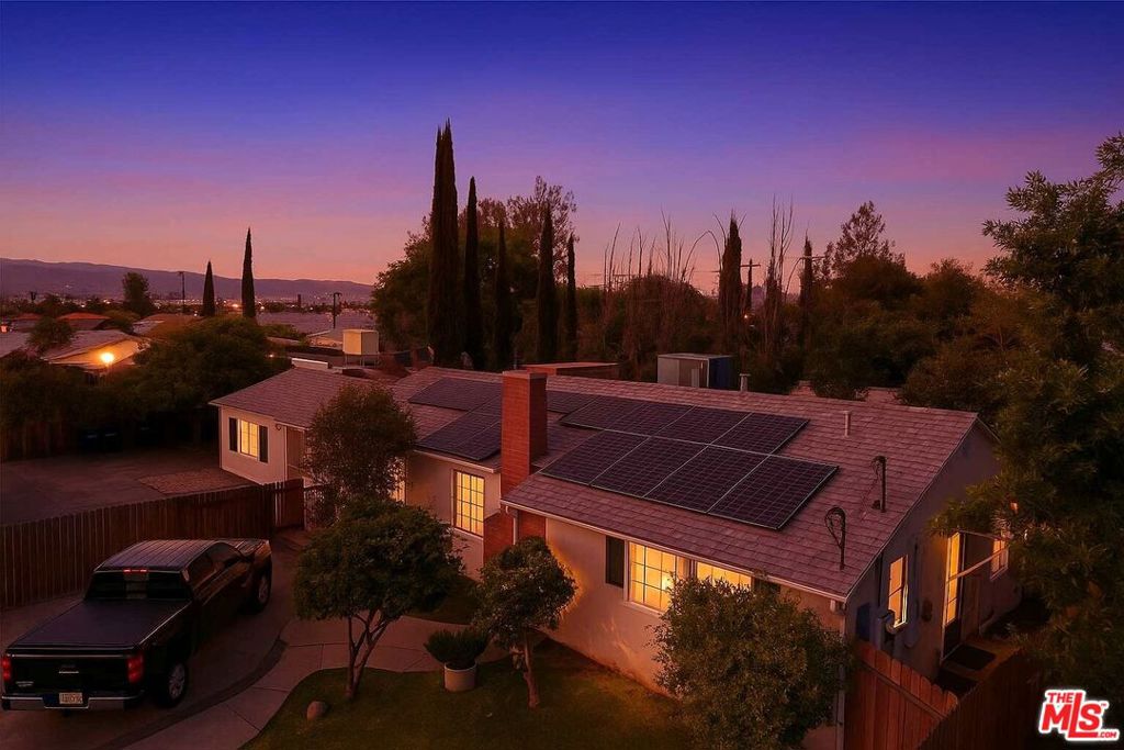A rare investment opportunity on an expansive 15,629 SF gated lot in one of Los Angeles most dynamic growth corridors. Behind a private horseshoe drive, the property offers two existing residences with separate addresses, plus ready-to-issue permits for a newly designed 1,200 SF two-story detached ADU delivering a unique combination of immediate income and long-term upside. The primary home features 3 bedrooms, 2 bathrooms, a light-filled living room, bonus room, and an updated kitchen with granite counters. The generous primary suite includes an en-suite bath, with two additional bedrooms and a covered patio ideal for entertaining. An attached 2-bedroom, 1-bath ADU offers approved plans for conversion into a Jr. ADU, further enhancing the property's income potential when paired with the new detached ADU build. The property currently has month-to-month tenants, paying $6,800 per month in rent - with projected gross income of approximately $11,000/month upon completion, this is a cash-flow asset in a prime location equally compelling for investors, developers, and discerning end-users.