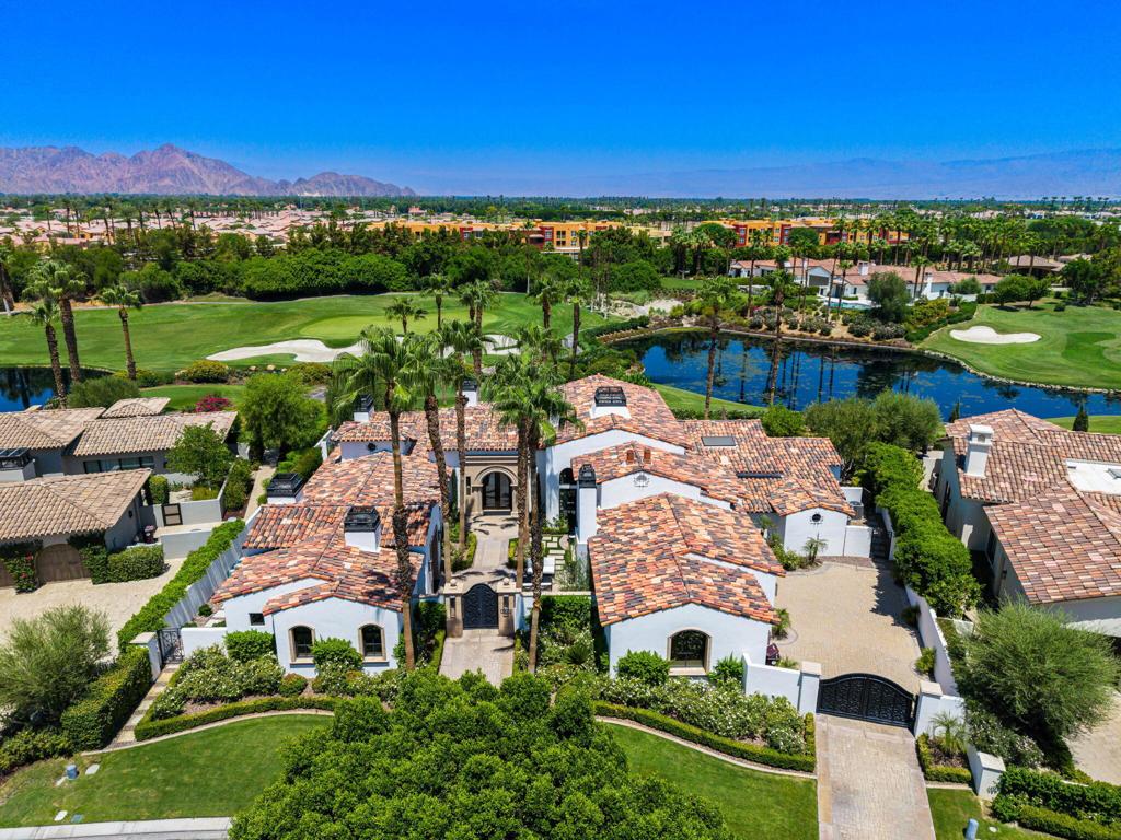 Beautiful custom home located behind the private gates at The Hideaway! This home was remodeled in 2021 and offers 5382 square feet of luxury living! Step through the iron gates that take you to the front courtyard with sitting area, fireplace, and entrance to the main house and guest house! This home offers a great room concept with travertine flooring throughout the home, large living area with ceiling to floor glass pocking doors, fireplace, incredible wet bar, wood beamed ceilings, game area, all for great entertaining! Step into the gourmet kitchen with dining area, large island with quartz counters and additional seating, ample cabinetry, Viking stove with gas cooktop, walk in pantry, and granite countertops! The dining area is just steps away and has 2 wine vaults. There are 2 bedrooms in the main house that includes the primary suite with sitting area, fireplace, direct access to the spa, soaking tub, walk in shower, and a large custom closet w/full bath! The third bedroom is located in the guest house that offers a living area with fireplace, kitchenette, bedroom, & bath! Step outside to the view overlooking the 3rd & 4th fairway of the Clive Clark Course. Pebble pool & spa, outdoor kitchen, putting green, fireplace, & large patio space for dining or relaxing poolside! This home is offered furnished including golf cart!