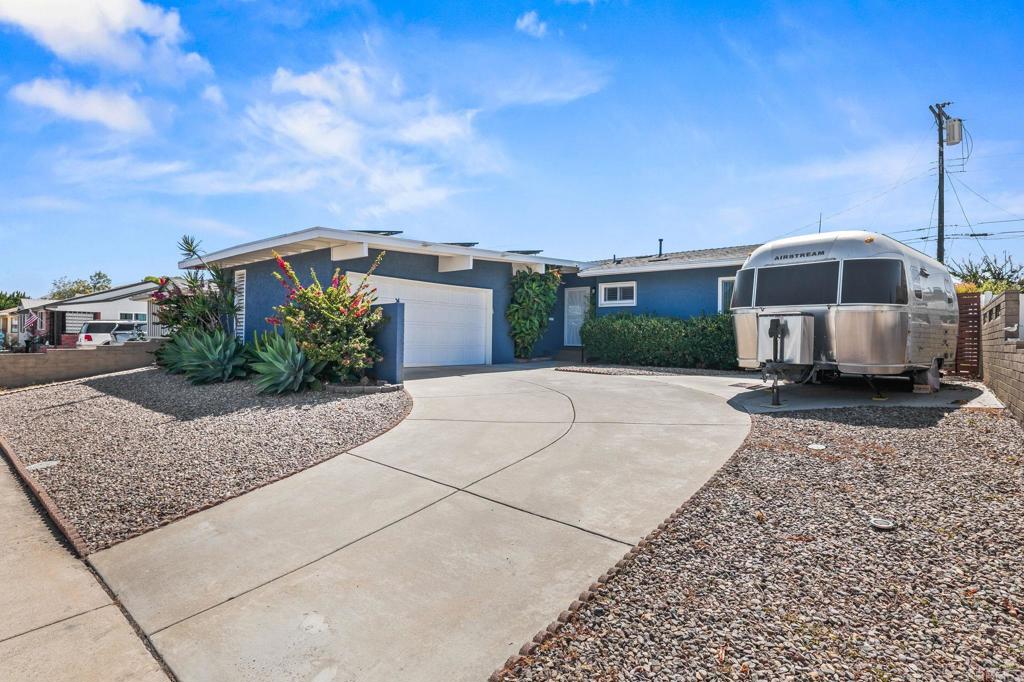 Beautifully updated light-filled home with vaulted ceilings - near schools, a shopping center, a community park/rec center and Mission Trails hiking area, with easy I-8 access. Recent enhancements include a new roof, outside house paint, epoxy garage floor and freshly painted garage walls. Newer gorgeous hickory hardwood floors throughout, with tile flooring in the 2 full bathrooms. Other features include plantation shutters, dual paned windows, fully owned solar (15 panels), indoor laundry space and newer furnace, A/C, water heater, plumbing, appliances and inside paint. Breaker box and most of electrical is less than 10 years old. The 3rd bedroom has been opened up, creating a spacious primary bedroom retreat. The wall could be reestablished for a 3rd bedroom if desired. The 2nd bedroom and bath are on the opposite side of the home from the primary suite, creating an ideal flow to the layout. The backyard is fenced and private, with low maintenance drip irrigation Xeriscape landscaping, newer blended turf (4 shades), and a covered patio with pavers. AT&T fiber internet already wired to the home. Come see this gem before it sells!