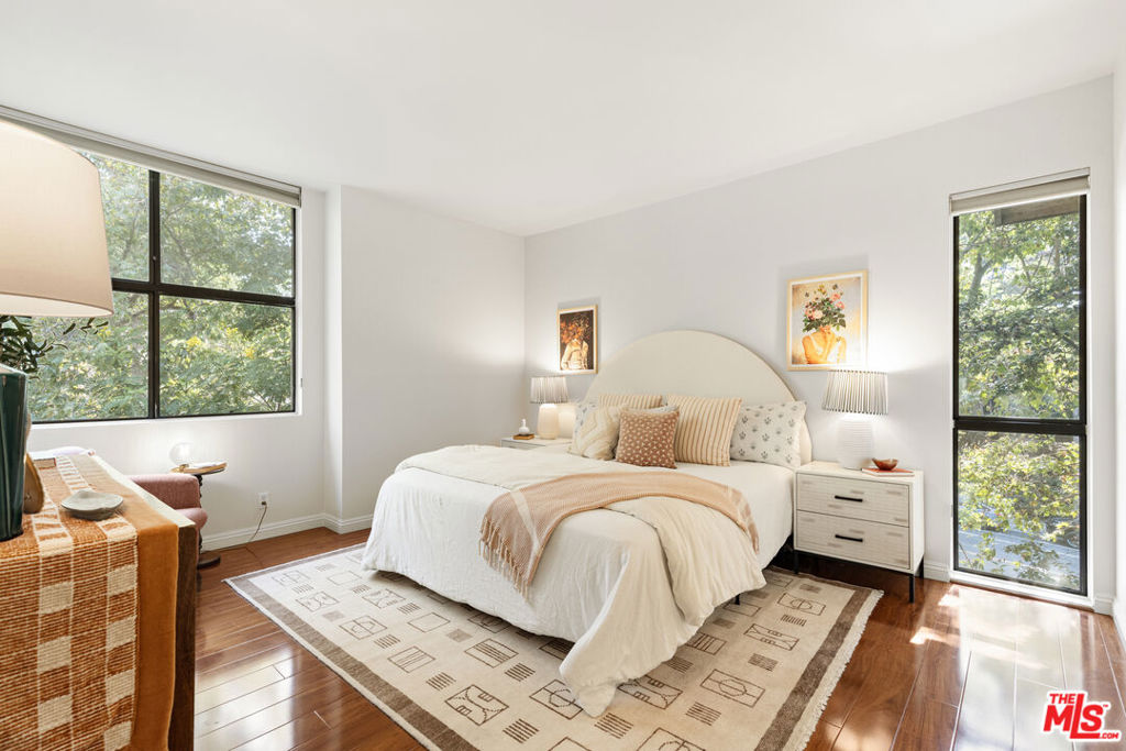 Welcome to this sunlit, top-floor corner residence at Drake Terrace in Monterey Hills, where high ceilings, peaceful views, and only one shared wall create a sense of airy privacy. With 1,174 square feet of thoughtfully designed living space, this home offers the best of easy California living. Enter through a lush, tree-lined courtyard (no dark hallways here!) into a bright, open living room where soaring ceilings and expansive windows frame treetop vistas. A cozy fireplace anchors the space, while sliding doors open to your private balcony -- perfect for morning coffee, evening wine, or simply soaking in the California sunshine. The kitchen is refreshed with newer stainless steel appliances, and in-unit laundry makes daily life a breeze. The oversized primary suite is quietly tucked away from the main living area and features a generous walk-in closet and en suite bath with a double vanity, while the second bedroom offers flexibility as a guest room, home office, or creative space. Enjoy resort-style amenities including a sparkling pool, spa, and sports court, and proximity to all the well-known Highland Park gems. Assigned garage parking is conveniently close to the elevator, and plentiful guest parking makes hosting effortless. A rare blend of light, space, and convenience -- 4147 Via Marisol is ready to welcome you home.