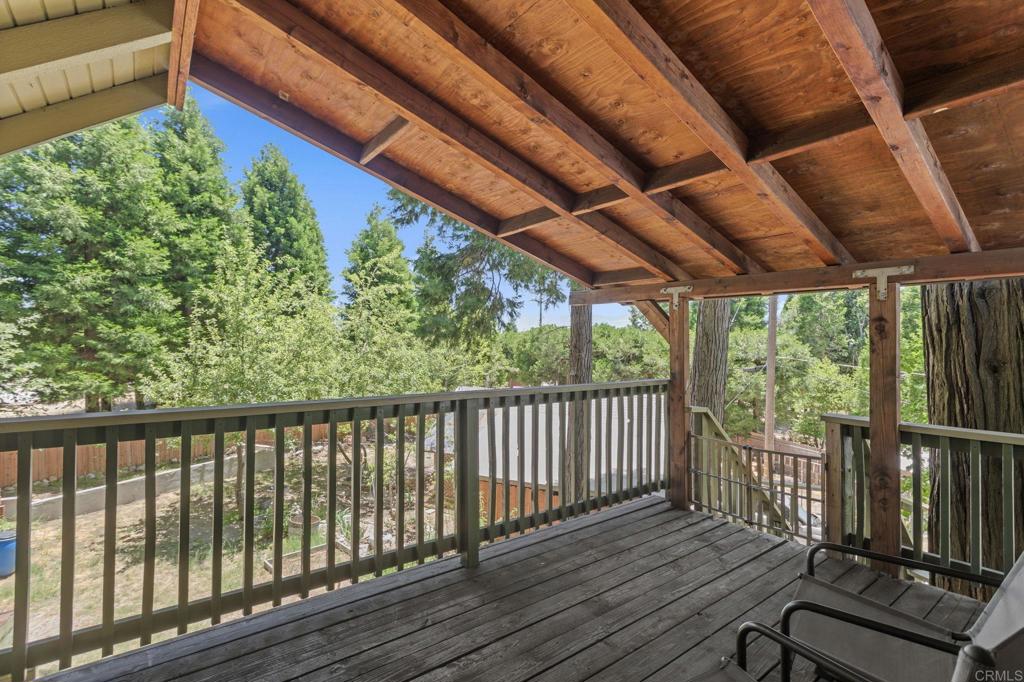 Welcome to your one-of-a-kind mountain home perfect for primary residence, vacation getaway, or Airbnb investment. Experience the Power of Mountain Living at 1148 Saturn, Crestline. Discover a rare opportunity to live in harmony with nature featuring a flat half acre lot fully usable and perfectly curated for a lifestyle of freedom, beauty, and functionality. Nestled among towering pines, this stunning mountain retreat offers a seamless blend of cabin charm and comfort. As you arrive, the expansive circular driveway welcomes you with ample space for guests, RVs, and boats an outdoor enthusiast’s dream. The charming variety of fruit trees and plants, including 2 apple trees, 3 pear trees, 2 cherry trees, 1 mulberry, wild strawberries, 2 peach trees, and 1 plum tree plus a mind and rosemary plant for refresh, aromatic herbs right at home. Step into your retreat through one of three main entrances and be instantly captivated by the exposed 100-year-old beams, soaring ceilings, and a striking rock fireplace with a brand-new insert a centerpiece of warmth and style. The open concept kitchen features granite countertops, stainless steel appliances, and natural flow into the living space, creating the ideal setting for both everyday living and entertaining. One bedroom, guest bedroom downstairs and full bath add flexibility. Upstairs, transform the oversized master bedroom suite into your personal master retreat. Step outside to the wrap-around deck and breathe in the crisp mountain air as you overlook your expansive sanctuary, complete with a hardscaped patio, garden beds, chicken coop, wood storage, and a lush grass area that rivals suburban backyards below the hill. This is more than a home it’s a lifestyle powered by nature, peace, and possibility.