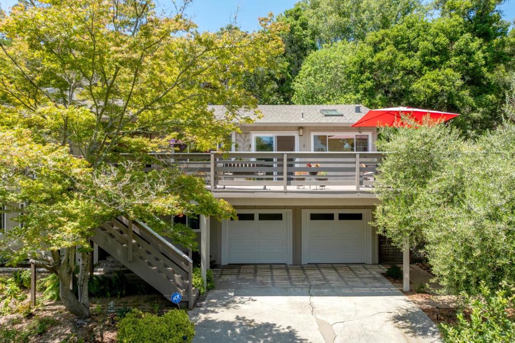 Experience tranquility and nature on this stunning 28,000 sq ft just minutes from Highway 17! This beautiful Scotts Valley home offers gorgeous views and a peaceful setting surrounded by mature trees. This home has been hosting hundreds of hummingbirds year-round. They're a symbol of joy, peace, and good luck. Acacia wood floors and floor-to-ceiling windows fill the home with natural light. The living room has a cozy fireplace and large windows and the separate dining room sits just off the kitchen with Corian countertops and a skylight. The front deck is perfect for outdoor dining or morning coffee. Spacious bedrooms on the main level offer ample closet space and access to the rear deck. Split-level layout suits multi-generational living with a separate downstairs entrance, three bedrooms, and a bonus room with a fireplace and library. Upstairs features three more bedrooms and two full baths. Enjoy the fully fenced yard with multiple areas to relax and entertain. The garden is filled with a variety of trees and plants. The plum trees are especially abundant this year, offering a generous harvest. Enjoy fragrant sage, rosemary, and lavender, along with cheerful, thriving succulents throughout the yard. Located in the top-rated Scotts Valley School District is a true retreat!