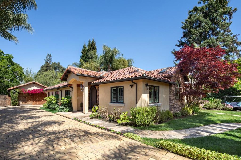 This Mediterranean villa offers a luxurious lifestyle in desirable Lloyden Park with a design for indoor/outdoor living. Spanning approximately one-third acre of complete privacy, the property showcases a resort-style rear yard with a well-appointed cabana, heated dining lounge, large spa, and putting green. Exquisite finishes, architectural ceilings, multiple fireplaces, and custom cabinetry enhance the interiors. There are 4 bedrooms and 3.5 baths across two levels, along with a recreation room, wine cellar, media room, and office. A large detached studio/fitness center with an adjoining bath provides flexibility for a variety of lifestyle needs. Behind the scenes, added features include EV charging, programmable lighting, distributed sound inside and out, and a security system. This home offers resort-style living with close-in convenience.