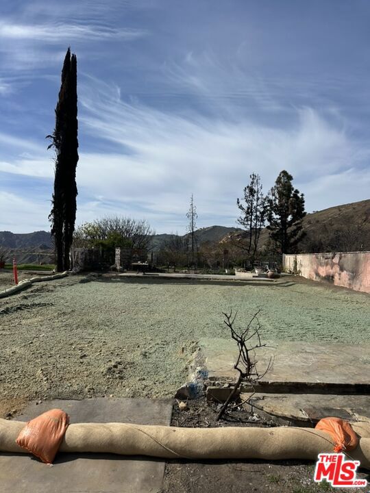 Reduced and ready to sell! The only lot below $1M in Pacific Palisades not on Sunset or adjacent to Sunset that is a flat lot and not sloped. EPA has completed Phase 1 AND Phase 2 debris removal work on the lot have both been completed. Nestled in the highly sought-after Palisades Highlands, this 6,344 SF lot offers breathtaking mountain views and an incredible opportunity to rebuild. With the ability to construct a 3,477 SF home plus an additional 10% bonus, totaling up to 3,825 SF without permitting hurdles, this property is a rare find. As the least affected area of the Palisades Wildfire, the Highlands is poised to be the first community to come back, making this an ideal investment in a beloved neighborhood.