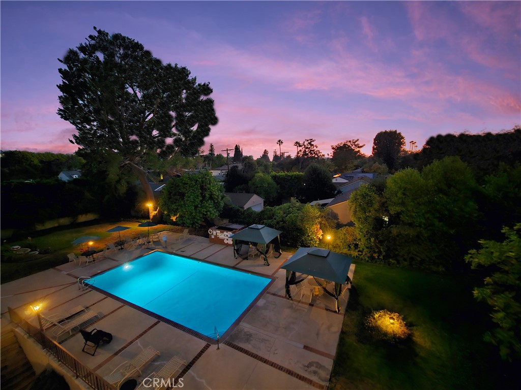 One of only 2 Units with this View! Stylish Single-Level Top-Floor End Unit in Prime Sherman Oaks—Feels Like a New York Loft! Nearly 1,500 Sq Ft! The Interior Design is centered on a Central Great Room encompassing the Living Room, Dining Area, and Kitchen, making it a great place to Relax and Entertain in a Modern and Comfortable Setting. Living Room & Dining Area boast Hardwood Floors, Recessed LED Lights, a Cozy Fireplace, and Sliders to a Balcony Overlooking the Rear Grounds and Sparkling Pool—a Rare View! The Bright Chef’s Kitchen Features Stainless Steel Appliances, a Breakfast/Buffet Bar, and Plenty of Storage. The Spacious and Serene Primary Suite includes a Spa-like Bath and a Huge Walk-In Closet with Built-ins. Secondary Bedroom and Bathroom have been designed with Neutral Colors and Décor. Stackable Washer and Dryer are located in the Laundry Closet. Amenities Include a Pool, Spa, BBQs, Large Recreation Room for Pool Parties, and His/Hers Saunas. HOA Covers Water, Insurance, Earthquake Insurance, Trash, and All Common Area Maintenance. Gated Parking with 2 Tandem Assigned Parking Spaces and Storage. Walking distance to the Highly Rated Kester Elementary. Just minutes to the 101/405 Freeways and Restaurants on Ventura Blvd. A Rare Find Combining Style, Space, and Convenience!