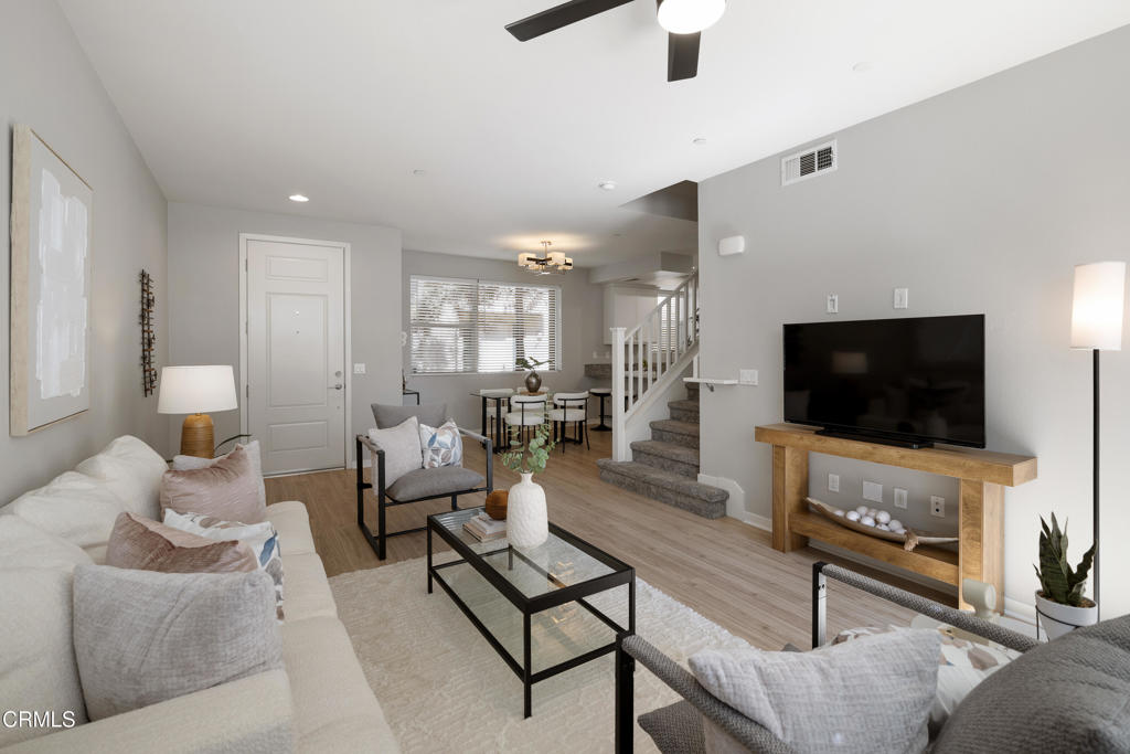 Behind the private gates of the sought-after VEO community lies a home that feels warm, refined, and effortlessly livable. This beautifully maintained 4-bedroom, 3-bath townhome offers the perfect blend of comfort, style, and connection, where every space invites you to slow down, gather, and enjoy the moments that matter most. From the moment you walk through the front door, you're welcomed by wood-like flooring and an airy, open layout that flows naturally from the living room. out to a peaceful private patio perfect for morning coffee, evening wine, or quiet conversation under the stars. The dining area opens to the kitchen, both functional and beautiful, featuring granite countertops, eat-at counter seating, recessed lighting, and sleek stainless steel Frigidaire Gallery appliances, with the exception of a Samsung refrigerator. A guest bath and direct garage access offer everyday convenience, while thoughtful storage under the stairs keeps life organized and easy. Upstairs, the primary suite feels like a retreat with its walk-in closet, ceiling fan, and spa-inspired ensuite featuring dual sinks, stone countertops, and a subway-tiled glass shower. Three additional bedrooms provide flexibility for family, guests, or a home office, each with soft carpet underfoot and gentle natural light. A full hallway bathroom, a dedicated laundry room, and modern finishes complete the upper level. Life in VEO is about more than just your home, it's about community. Enjoy resort-style amenities, including a sparkling pool and spa, clubhouse with kitchen and pool table, fire-pit, and playground. Whether it's a weekend barbecue, a swim under the sun, or an evening stroll through the gated grounds, this is a place where neighbors become friends and every day feels a little brighter, ideally located in close proximity to Ralph's Grocery Store with a private entrance from the complex to the store. Experience the ease of modern living and the warmth of true community in this turnkey townhome gem.
