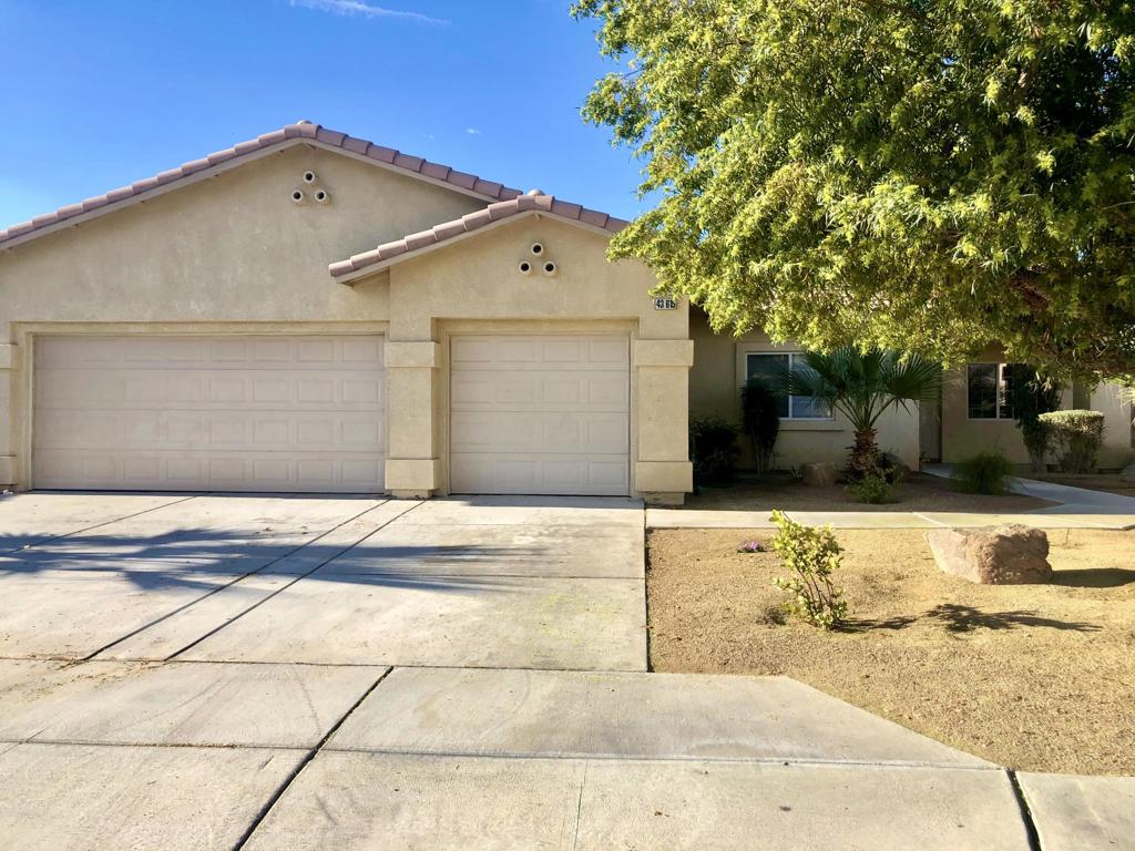 adorable 3 bedroom 2 bath home in Indio is ready for an immediate long term lease. This home is spacious with tile and carpet throughout. This home has an open floor plan and is light and bright with all appliances including stove, microwave and dishwasher. Eat at the breakfast bar or your spacious dining room.Enjoy your professionally landscaped private back yard, includes a side yard that would be a great dog run. The home comes with a two car attached garage with extra storage.