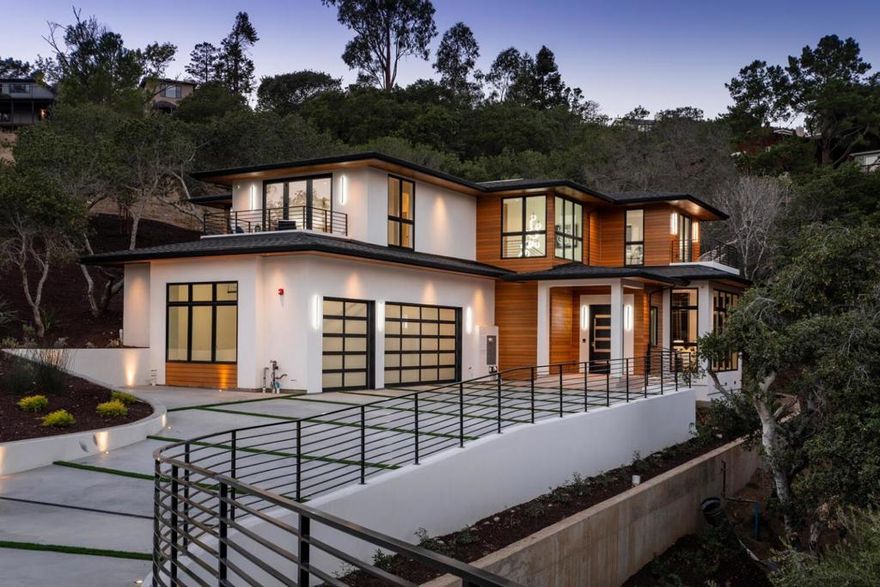 Gracefully set back on a ±25,000s.f. lot, this brand-new contemporary masterpiece exudes meticulous attention to detail, exemplary craftsmanship, and designer finishes throughout. Offering ±4,050s.f. of living space, this 5BR/5.5BA home features LED lighting, an elevator, multi-zone heating & A/C, and a Crestron whole-house automation system for lighting, temperature, music, window coverings, security system, video surveillance & more. Added features include a stunning great room with a wall of windows, grand fireplace & French doors that open to a large patio. The chefs kitchen offers Miele appliances, motorized upper cabinets, & an adjoining dining room with a folding glass wall that opens to the covered patio replete with outdoor kitchen, fire pit, & waterfall. 4/BR with ensuite baths, a secondary family/media room opening to a courtyard patio, & the primary suite with covered balcony adorn the upstairs. A 3-car garage & 2 laundry rooms complete this amazing, one-of-a-kind property.