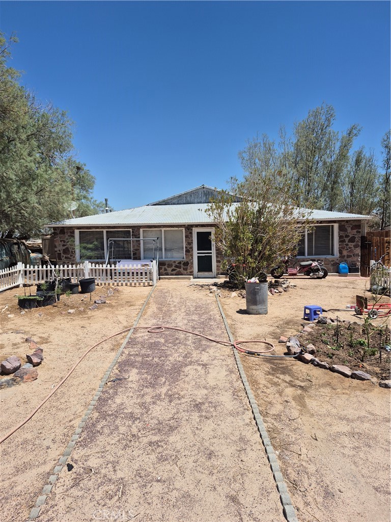 An oasis in the desert? Come to see this beautiful property located just minutes from the 40 freeway and just 20 minutes from Barstow. This house features 5 bedrooms 3 baths( Buyer to verify permits) sit in a huge lot totally fenced full of trees and a chicken coop., Enjoy the beautiful sunset from the front windows. House in been updated lately with laminate floors and extra room for you convenience. If you like the countryside and a quiet environment this home is waiting for you. This home has too much potential and the room for you to dream big.