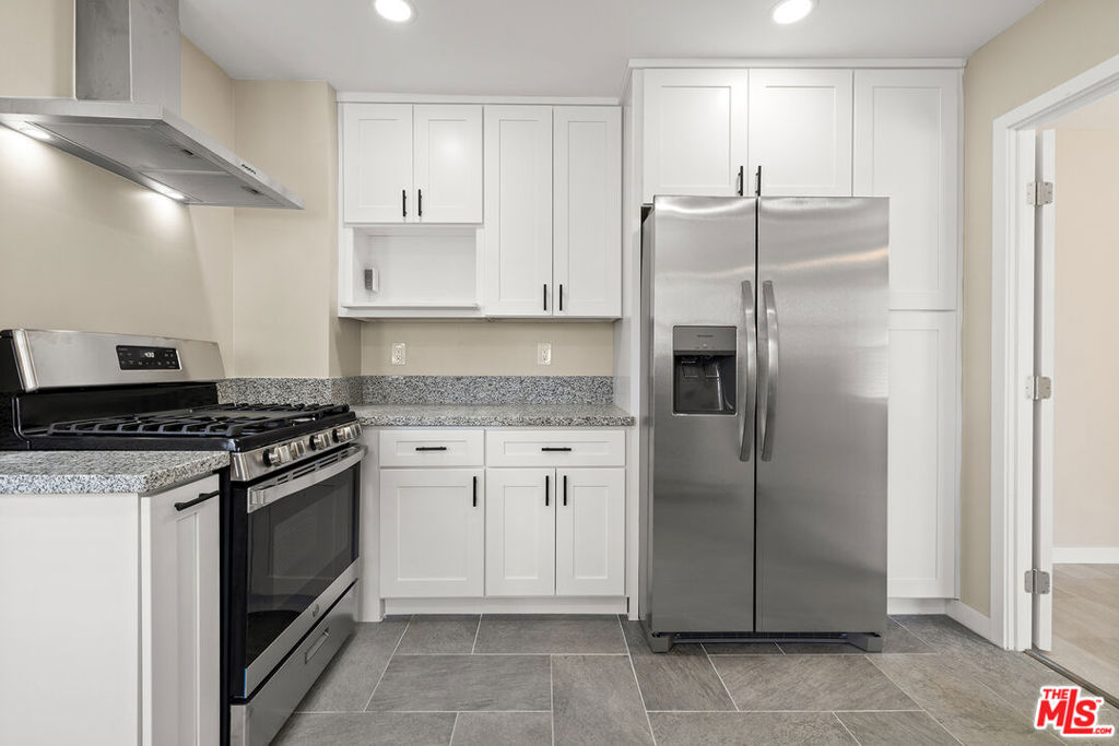 This beautifully renovated 2-bedroom, 1-bathroom unit has just been completely updated and is ready for its next resident. The interior features brand-new plumbing, fresh paint, recessed lighting, and vinyl plank flooring throughout. Each room is equipped with a brand-new mini split A/C unit and ceiling fans in both bedrooms for year-round comfort. The spacious, updated kitchen includes new cabinetry, granite countertops, and brand new stainless steel appliances, including a stove/oven, refrigerator, and an all-in-one Samsung washer/dryer combo. The renovated bathroom offers a tiled shower, modern vanity, and updated fixtures, designed in a Jack-and-Jill layout with direct access from both bedrooms. One bedroom also includes a private entrance, offering added flexibility. New blinds throughout provide privacy and light control. The unit is located in a well-maintained fourplex with on-site management and features both front and rear access, offering a private, home-like atmosphere. Conveniently located just minutes from the 110 Freeway and several Metro bus lines, with easy access to downtown LA, USC, Exposition Park, and BMO Stadium.