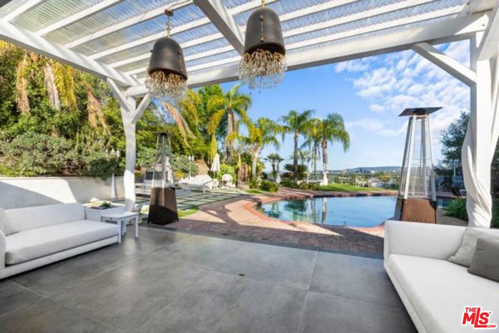 Perched atop a generous .35 acre sprawling lot, discover Modern elegance on a single level residence that celebrates indoor - outdoor living, with impressive, sweeping views of the skyline and city lights. This scenic, stunningly remodeled and updated home includes plumbing, eletrical, roof, and is located in a highly desirable enclave of West Hills invites you through it's heart - the beautifully appointed chef's kitchen with a tastefully oversized island, and elegantly wrapped in natural leathered quartzite stone and exceptional materials finishing the functional seld closing drawers. Fisher & Paykel refrigerator, and Zline Autograph Signature collection cooktop, hood, and washing machine, Miele espresso coffe system, custom kitchen cabinets crafted from German oak wood and adorned with Italian live brass accents. The bar and flooring throughout the house are enhanced by recessed RGB remote-controlled LED lighting, allowing for customizable mood settings. A fully self contained ADU, thoughtfully designed with it's own separate entrance, patio, and outdoor spa tub offers full autonomy, ideal for income potential or extended family. The home provides bright, open interior sun filled interiors with vaulted ceilingss, walls of glass, seamlessly connecting to the expansive outdoor entertainer's dream with a flat, usable, expansive back yard with chic resort moments to relax, meditate, including the sparkling resurfaced swimmer's pool, and gas and wood burning outdoor firepits, a covered bar for the most magical lifestyle of year round resort living. Memorable movie nights will be an experience of it's own, with a dedicated home theatre in an 85" LED display and projection screen, and walls covered in striking cheetah print by Roberto Cavalli. Each bedroom has it's own wall-to-wall closets to maximize storage space. Lighting fixtures throughout the home are by Italian designer Nick Alain. In the master bathroom, you'll find a luxurious steam system, body massage jets, a stunning waterfall shower, and a rain shower, all complemented by Bluetooth speakers for an enhanced experience. The flooring throughout the space consists of exquisite 4x4 Italian ceramic tiles. Contact the listing agent to make an appointment via text or email. There are 3 bedrooms in the main house, 4th bedroom is the ADU with final permits pending. Buyer to verify square total square footage of home.