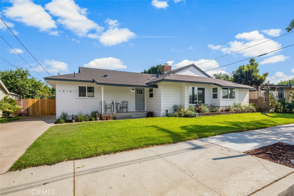 10181 Lampson offers a freshly remodeled 1,713 square foot single story residence on an 8,400 square foot lot with an outstanding detached 29 foot by 19 foot garage, perfect for a potential junior ADU conversion! The home has fantastic curb appeal, freshly painted with wood paneling, fresh front yard landscaping and a New Roof! Upon entry you are greeted by new LVP flooring, recessed lighting and all new dual pane windows and sliding glass doors. The spacious living room and dining area are highlighted by a beautiful mid-century style gas burning fireplace, have direct access to the covered patio and rear yard, and are conveniently located near the kitchen. Your newly remodeled kitchen features white shaker cabinetry, quartz countertops, stainless steel appliances with a gas range & range hood and a stylish tile backsplash. A full sized laundry room is located off of the kitchen for convenience. Your graciously sized primary bedroom has direct access to a renovated bathroom with a large glass enclosed shower and dual vanities. Two additional bedrooms, also well sized, share a second bathroom, one with direct access that also services your guests. Endless possibilities exit with your oversized and secluded rear yard. The driveway leading to the detached garage can accommodate multiple vehicles or an RV if the new owner desires. Additional features include: Updated Furnace and AC and landscape irrigation.