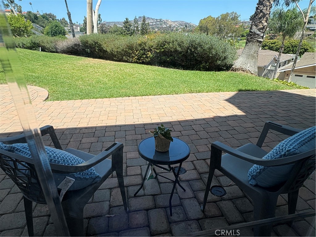 Fantastic location! Near the Coast Highway, beach access trail and downtown! Ground level, single story unit with spacious patio adjacent to a large lawn beside the pool and hot tub. Panoramic view of the hills and homes of San Clementeans well as golf course views. Beautiful wood flooring, ceiling fans, beveled glass sliders and other unique features and amenities make for gracious living or a comfortable getaway or investment property! This is something YOU MUST SEE to fully appreciate! It's the coolest condo ever!