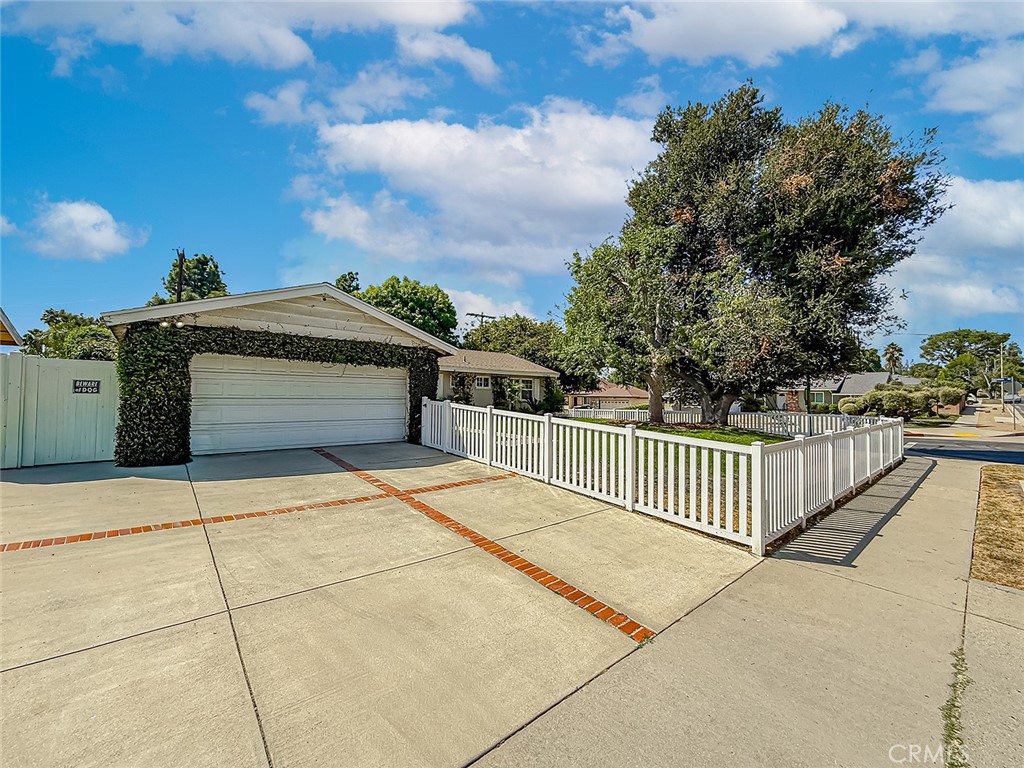 Charming Mid-Century Ranch in a Prime West Hills Pocket! Welcome to this beautiful single-story mid-century ranch home tucked behind a gated front yard in one of the most desirable neighborhoods of West Hills. Featuring 3 bedrooms, 2 bathrooms, and 1,144 sq. ft. of living space on a generous 8,056 sq. ft. lot, this home blends timeless charm with thoughtful upgrades. Step inside through the elegant leaded glass front door into a warm tile foyer that opens to a bright and inviting living room—perfect for entertaining. Sliding glass doors lead to the covered patio and backyard, creating seamless indoor-outdoor living. The kitchen is open to the living area with a cozy breakfast bar and features updated cabinets, custom tile countertops and backsplash, GE gas range/oven, Samsung dishwasher, built-in microwave, and direct access to the attached 2-car garage. The primary suite offers a private ensuite bathroom with a beautifully upgraded tile shower. Two additional bedrooms share a hallway bath showcasing a large walk-in tile shower, pedestal sink, and modern finishes. Upgrades include: Central heating & air conditioning, Dual-pane windows, and Upgraded interior doors. The backyard is a private retreat with a covered patio and grassy play area, perfect for relaxing evenings. Conveniently located near shopping, dining, schools, and parks. Don’t miss this wonderful opportunity to own a move-in ready home in a sought-after West Hills pocket!