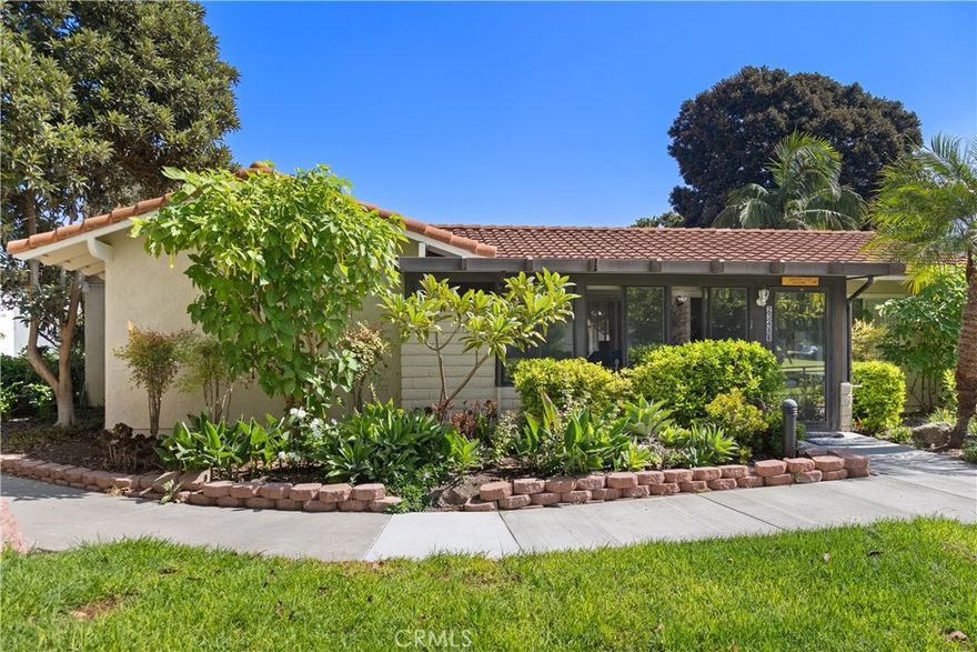 YOU WILL NOT WANT TO MISS THIS POPULAR "SAN SEBASTIAN" CONDO COTTAGE. SINGLE LEVEL LIVING WITH NO STAIRS AND NO ONE ABOVE OR BELOW. Just a short walk to Clubhouse 4 for the art studio, ceramics, jewelry making, and the world-class woodshop, along with a lap pool and jacuzzi.  An inviting garden walkway leads to a wonderfully enclosed patio off the living room, which can be used as a music room, office, studio, craft room, or an excellent space for entertaining. It also serves as a welcoming space to greet guests and enjoy the expansive, lush greenbelt view!  GREAT CURB APPEAL!

Inside, the spacious living room features vaulted ceilings and track lighting that create an open, airy feel. The dining area sits just off the kitchen and enjoys cheerful neighborhood views. The kitchen offers abundant counter space and cabinetry, a window over the sink, and a convenient door to the outside for effortless everyday living. The two separate bedroom layout provides privacy for you and your guests. The primary bedroom has mirrored closet doors, a beautiful greenbelt view from the window, and has its own en suite bathroom. The guest bedroom is generous and also has an excellent view to enjoy waking up to. There are two bathrooms: one with a tub and shower combo, and the other with a step-in shower, each featuring a large vanity and helpful grab bars. Additional highlights include excellent natural light from multiple exposures and nearby carport parking with extra guest spaces. In addition, it has two entrances: a front and a back door, and a shared courtyard area outside the back. You'll love the wonderful cross breeze this home offers. 

The easy living single-story design makes this home an excellent opportunity to move in now and personalize at your own pace. Add the unbeatable Laguna Woods Village amenities, and you have the complete package. Enjoy the 27-hole championship golf course or the 9-hole executive par three, tennis, paddle tennis, pickleball, lawn bowling, two fitness centers, seven clubhouses, five swimming pools, an equestrian center, gardening areas, art studios, a world-class woodshop, and over 250 clubs and organizations. Take advantage of the free community bus service to nearby shopping and local destinations, as well as convenient and economical RV parking in the community storage area. Country Club Living at its best, approximately 6 miles from beautiful Laguna Beach. The best hidden secret in Orange County. Carport 2234 Space 15