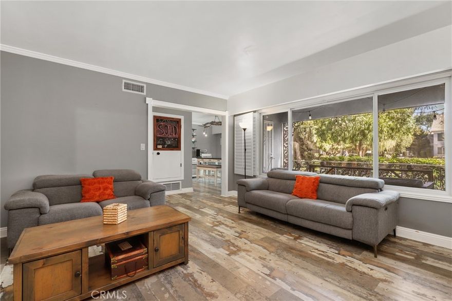 Welcome to your beautifully upgraded home in the desirable Meredith Manor community! As you enter, you’ll immediately notice the incredible custom touches and thoughtful design throughout. The spacious, open floor plan is filled with natural light streaming through an abundance of double-paned windows, highlighting the elegant crown molding. The inviting living room features a charming two-sided fireplace and large shuttered windows that overlook the private patio and courtyard with a sparkling pool — perfect for relaxation or entertaining. The kitchen is a true showpiece with custom countertops, a copper sink, and a beautifully designed backsplash. It opens seamlessly to a large dining area surrounded by picturesque windows, creating an ideal setting for gatherings. The generously sized primary suite offers a remodeled, modern full bathroom with a walk-in shower. The additional bedrooms are roomy and comfortable, and the hallway bathroom has been updated with the same stylish, contemporary finishes. Enjoy the convenience of a large in-unit laundry room with full-size washer and dryer hookups and plenty of extra storage space. A two-car garage is located just steps from your front door. With one of the lowest HOA fees in Orange County, you’ll enjoy great value — including water, trash, pool, and grounds maintenance. This downstairs unit offers the ease of single-level living with no stairs. Located less than two miles from downtown Fullerton and close to restaurants, shopping, the train station, freeways, and Cal State Fullerton — this home offers comfort, style, and convenience all in one.