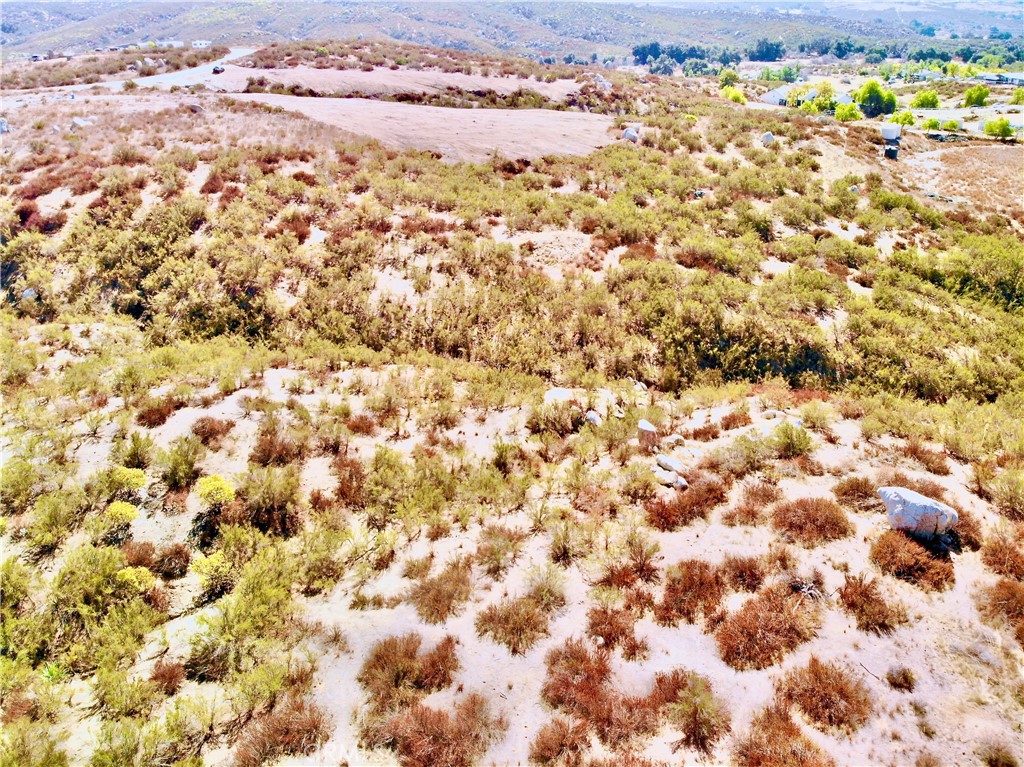 Discover this gently sloping 2.39-acre lot offering panoramic views of rolling hills, meadows, and distant mountains—perfectly suited for a custom home, ranch, or agricultural retreat. Located along a private, unpaved road in a tranquil foothill setting, this parcel blends solitude with accessibility and is approximately 20 minutes from the renowned Temecula wine country. Zoned Rural Residential (R-R), the lot supports a range of uses including manufactured and custom-built homes, hobby farms, equestrian setups, or other rural development. Essential services—including electricity, phone, and potential for propane and well/septic—will be needed. A quote for services has been drafted for buyers considerations. The openness provides a blank canvas for building or landscaping, and with no HOA restrictions, you’ll enjoy complete flexibility. Surrounded by open terrain and peaceful countryside, this property invites limitless possibilities. (Buyer and agent should verify zoning, utilities, and development suitability.)