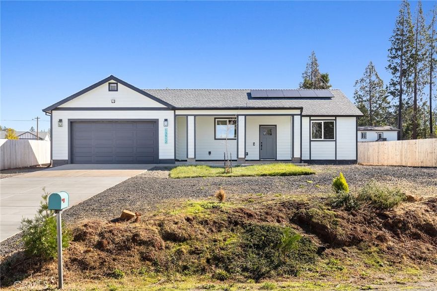 Tucked away in the beautiful pines of Magalia, this picture-perfect home has been crafted with exceptional attention to detail and quality throughout. Every inch of this property reflects pride of ownership and thoughtful design, giving you that “brand-new home” feel the moment you arrive. Step inside and you’ll immediately notice the bright and airy atmosphere created by the open floor plan, soaring vaulted ceilings, recessed lighting, and wide windows that let the natural light pour in. The gorgeous vinyl flooring ties the space together perfectly, while the spacious living area invites you to sit back, relax, and enjoy cozy evenings in or gatherings with loved ones. For the chef in the family, the kitchen is an absolute showstopper. It comes fully equipped with an abundance of cabinetry for storage, stunning quartz countertops, a sleek subway tile backsplash, a large farmhouse-style sink, and top-of-the-line stainless steel appliances including an electric range. The charming center island with a breakfast bar adds the perfect spot for morning coffee or quick bites on the go. When it’s time to unwind, the primary suite is your personal retreat. Generously sized and beautifully designed, it features dual closets and a spa-like ensuite bathroom that feels straight out of a magazine. You’ll love the dual sinks, expansive vanity, unique tile flooring, and the eye-catching tiled walk-in shower that’s truly a statement piece. This home also offers two additional spacious guest bedrooms, ideal for family, guests, or even a home office. With ceiling fans throughout, an attached two-car garage, and owned solar panels to help you save on utility bills, convenience and comfort go hand-in-hand here. Step outside and imagine the possibilities. The backyard provides a blank canvas ready for your personal touch. Whether you dream of adding a garden, a storage shed, a patio, or simply creating a quiet space to enjoy the mountain air, this property gives you room to grow. Full of charm, function, and modern style, this Magalia gem truly has it all. Don’t miss your chance to make it yours!
